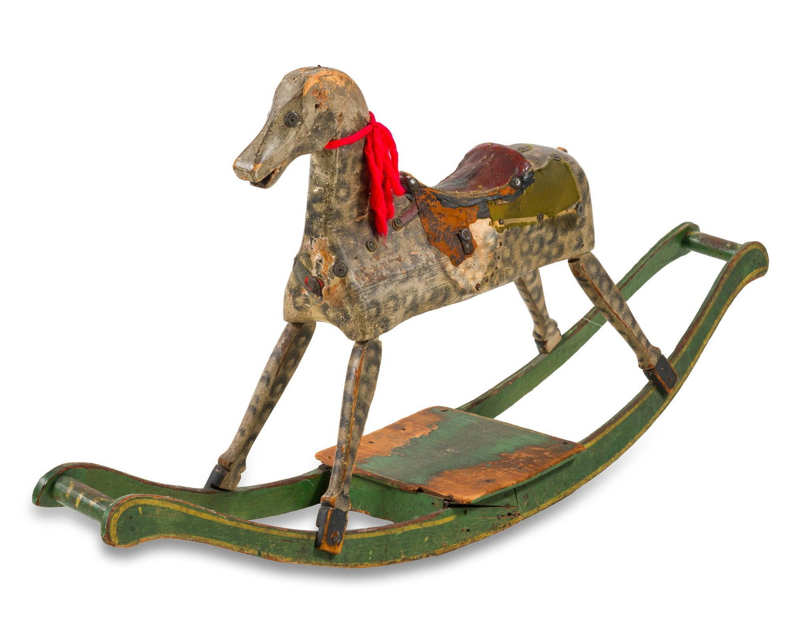 Folk Art Riding Horse: A very fine and charming carved wooden folk art riding horse probably south central Pennsylvania circa 1820-50. The form consisting of a green ground and dapple painted carved wooden horse