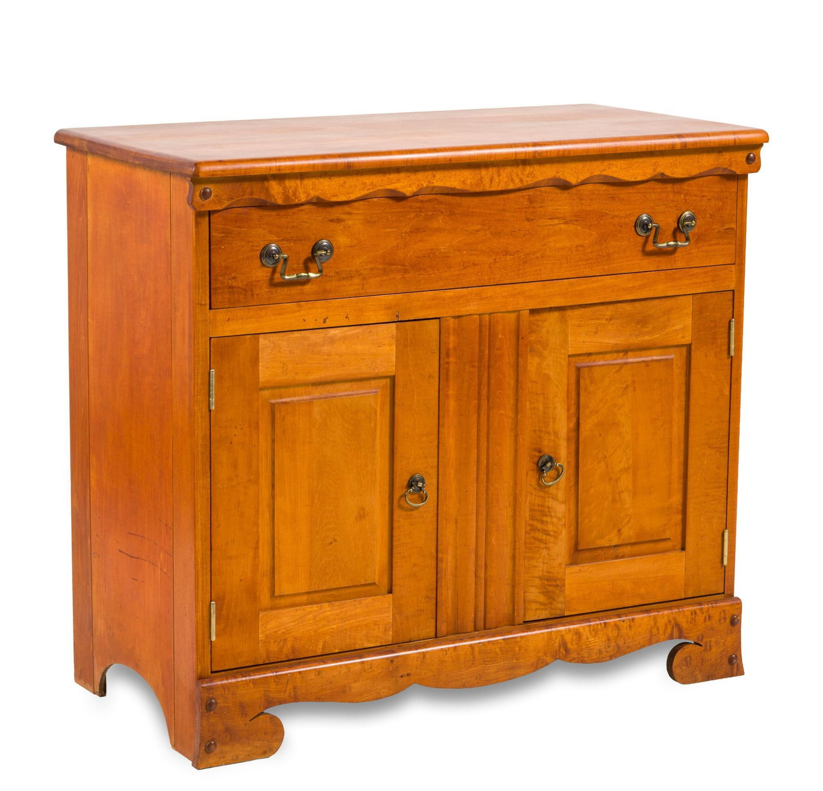 Low Cabinet: A revival low cabinet made and/or retailed by the Ebert Furniture Company of Red Lion Pennsylvania. The form consisting of a softwood case resting on stylized bracket feet with a double blind door