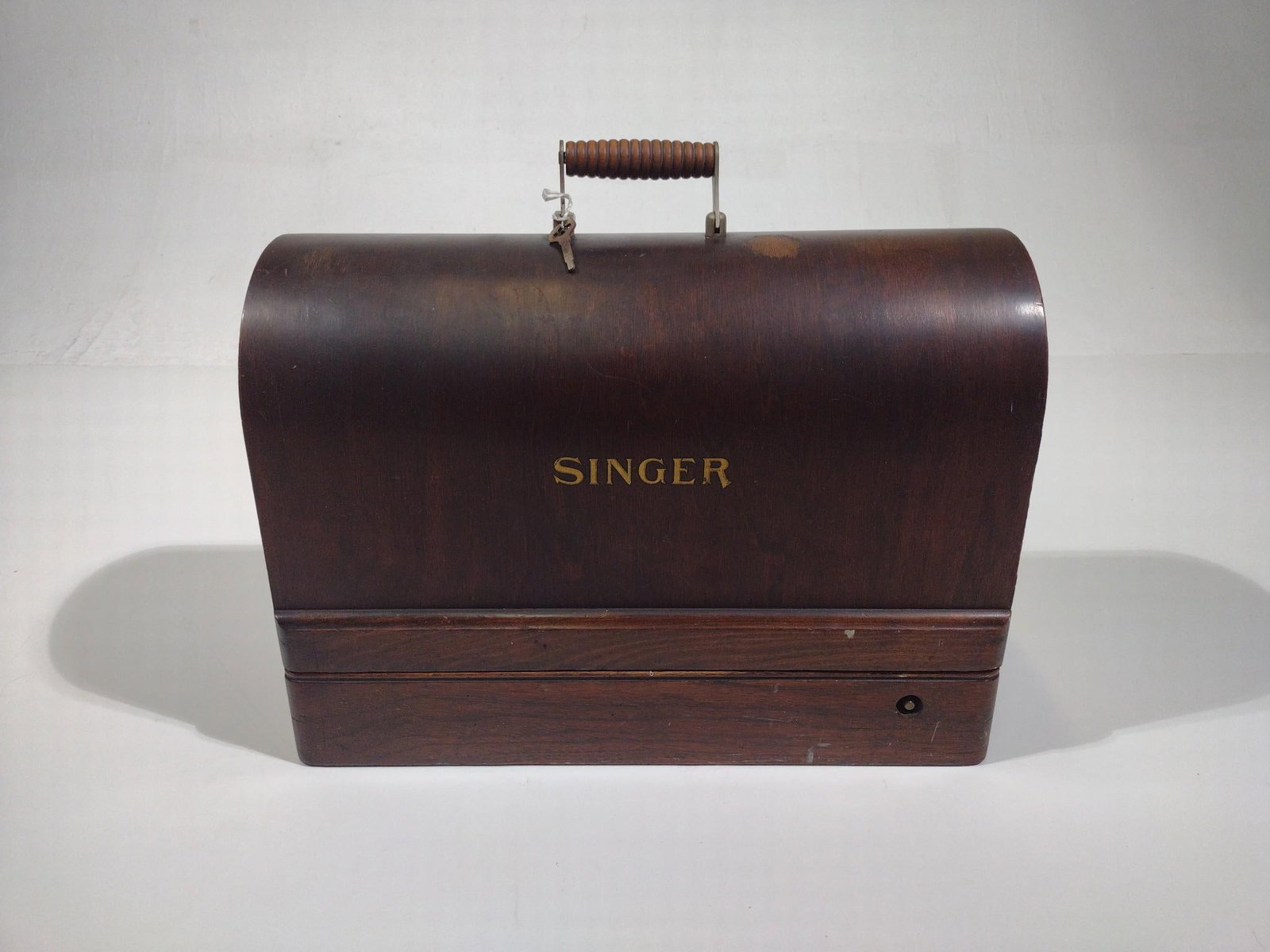 Singer Traveling Sewing Machine: Serial number Y713666. With key. 17-1/8" wide x 12-1/2" high. 