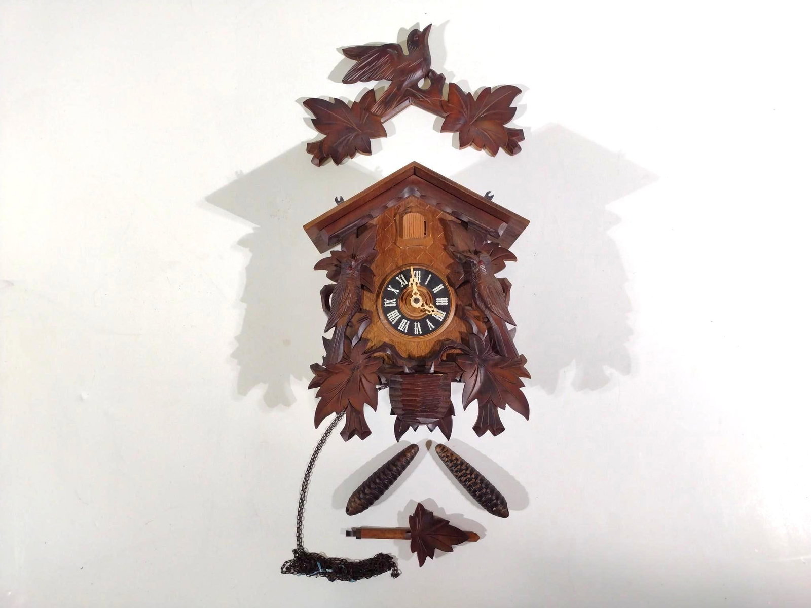 Black Forest Cuckoo Clock: 10" wide x 18-1/2" long. Top has been repaired. Slight losses to face.