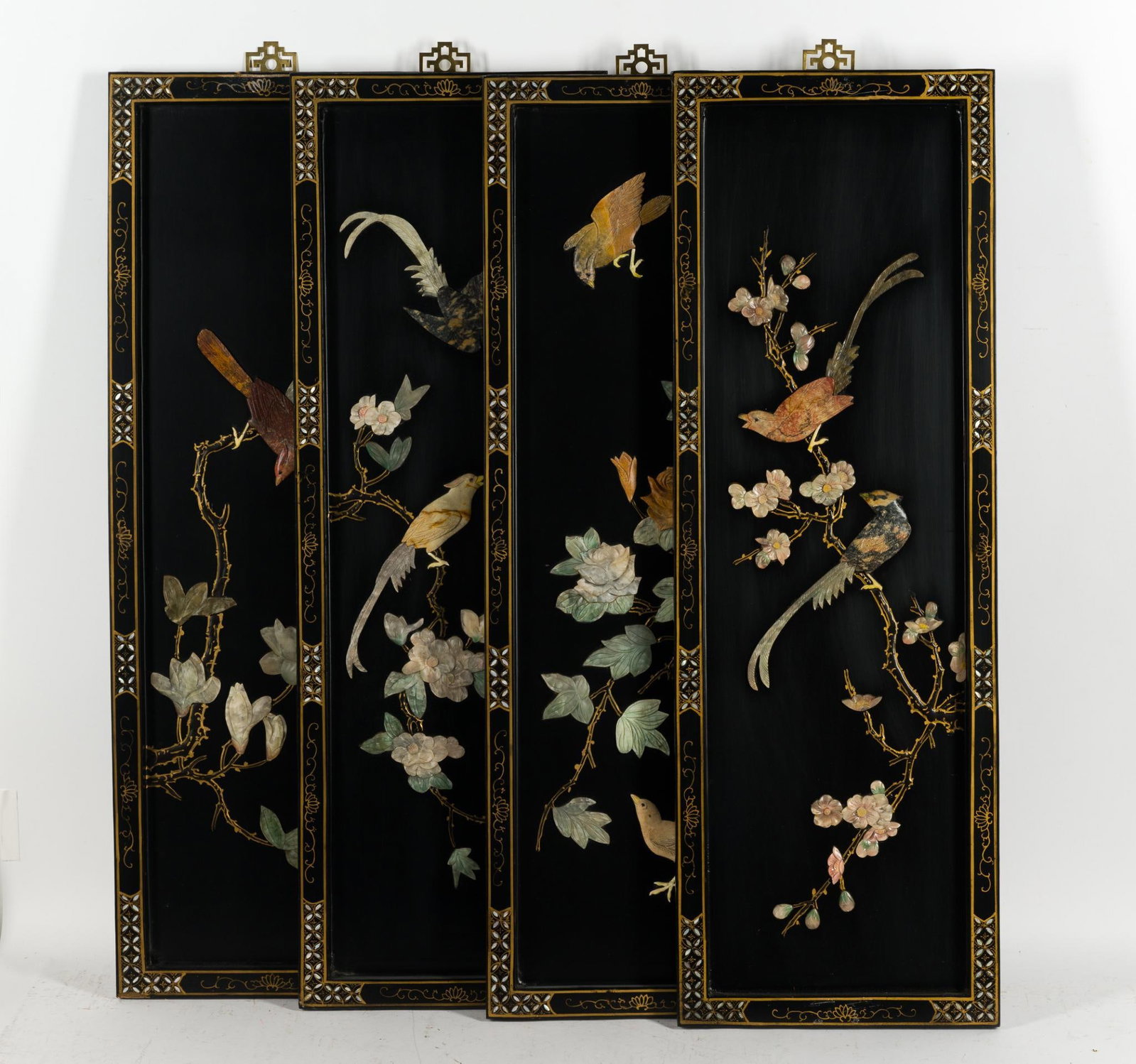 Set of 4 Chinese Black Lacquer Panels: Each panel has mother of pearl inlay and carvings. The panels are 36" X 12" each.
