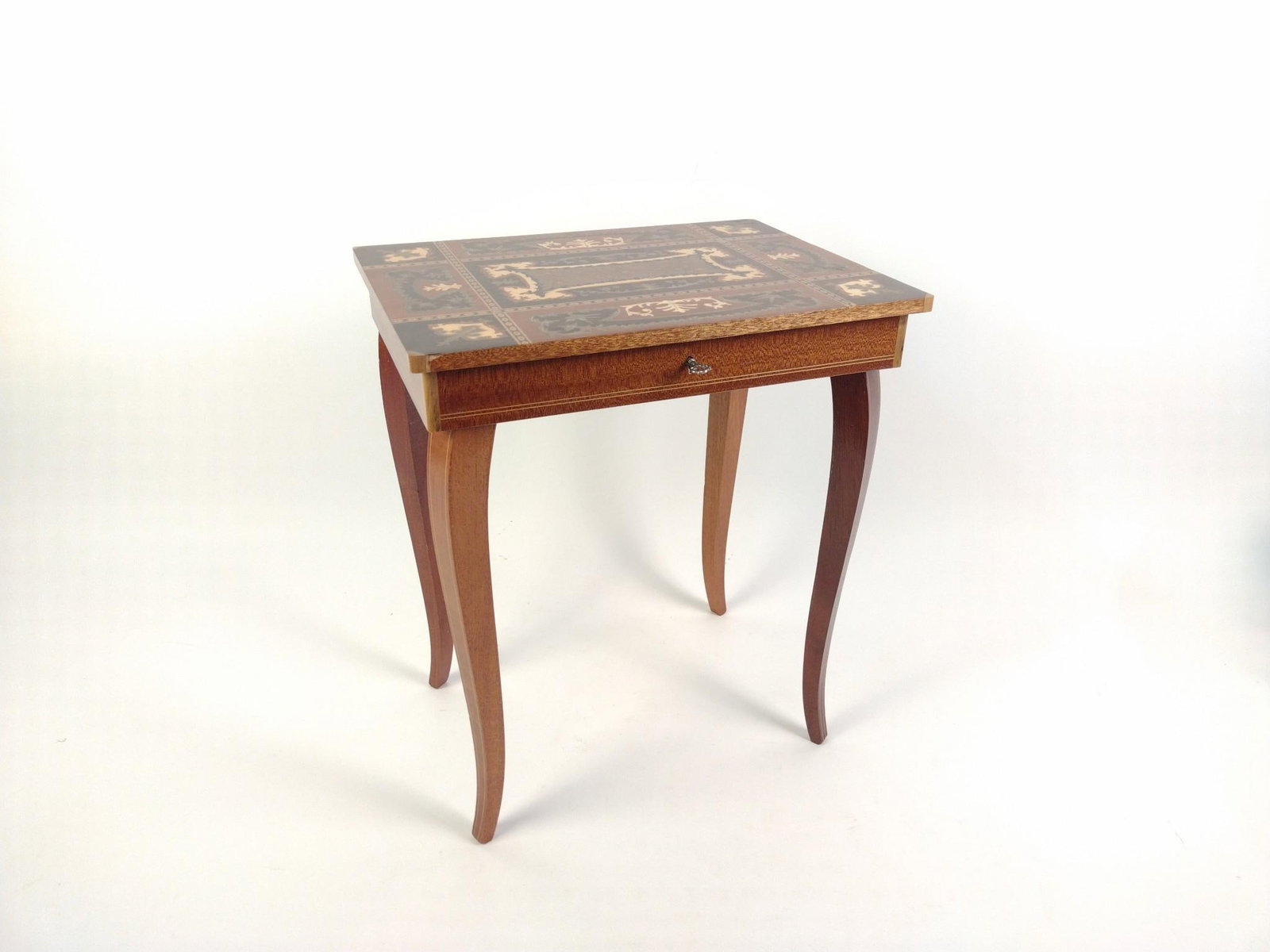 Vintage Swiss Inlaid Music Box Table: In working condition, Some small scratches to the legs, top of the inlaid table has some light scratches and dents as well. Measures 14-1/2" x 10-3/4" x 16-3/4". 