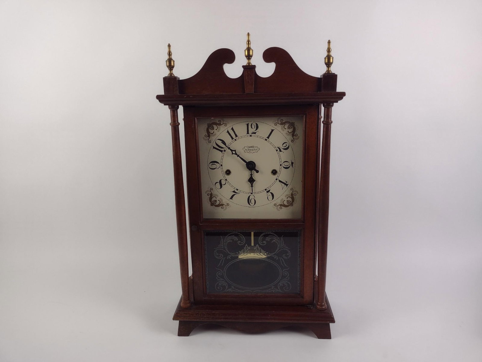The New England Clock Co. Mantle Clock: Eight day spring wound. Untested. Measures 13" x 6" x 24". 