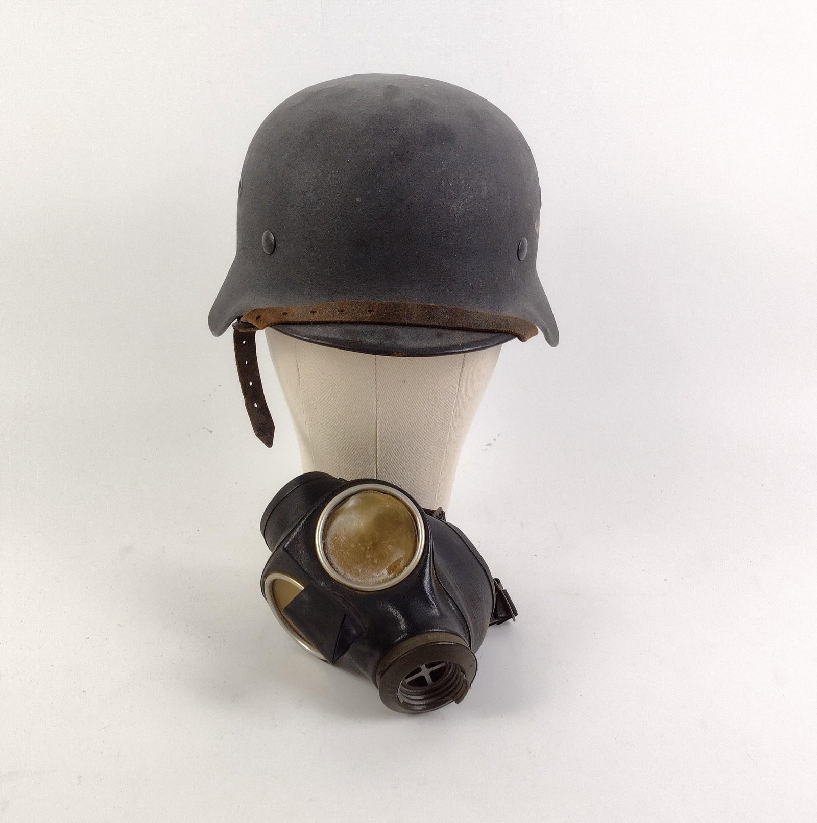 German WWII M31 Luftwaffe Helmet & Luftschutz Gas Mask: Helmet has original leather liner with "59" stamped on the lining. "11616" is stamped on the rear center metal. Gas mask stamped "G29." Helmet measures .11-1/4" x 9-1/4" x 6-1/2", and gas mask