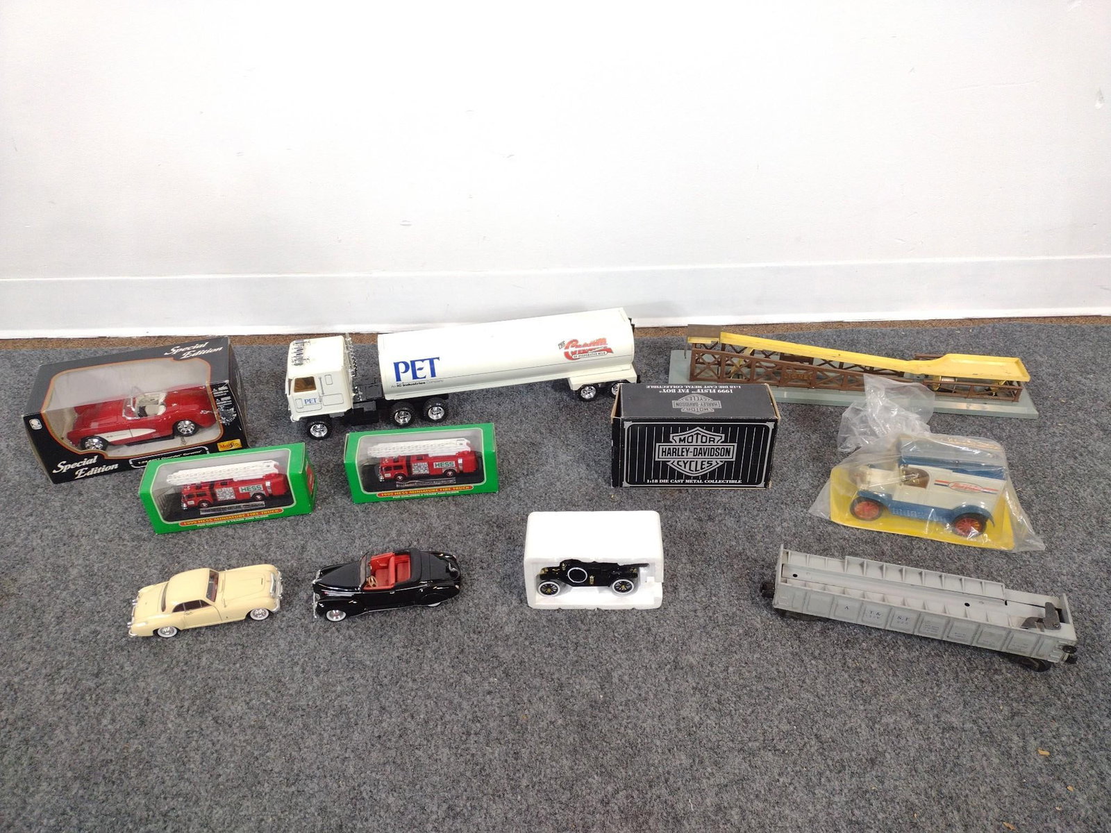 10 Model Cars & Trains: Includes Lionel, Harley Davidson, and more. All in original boxes. 3" to 4-1/2" wide x 5-1/2" to 19-1/2" long. 