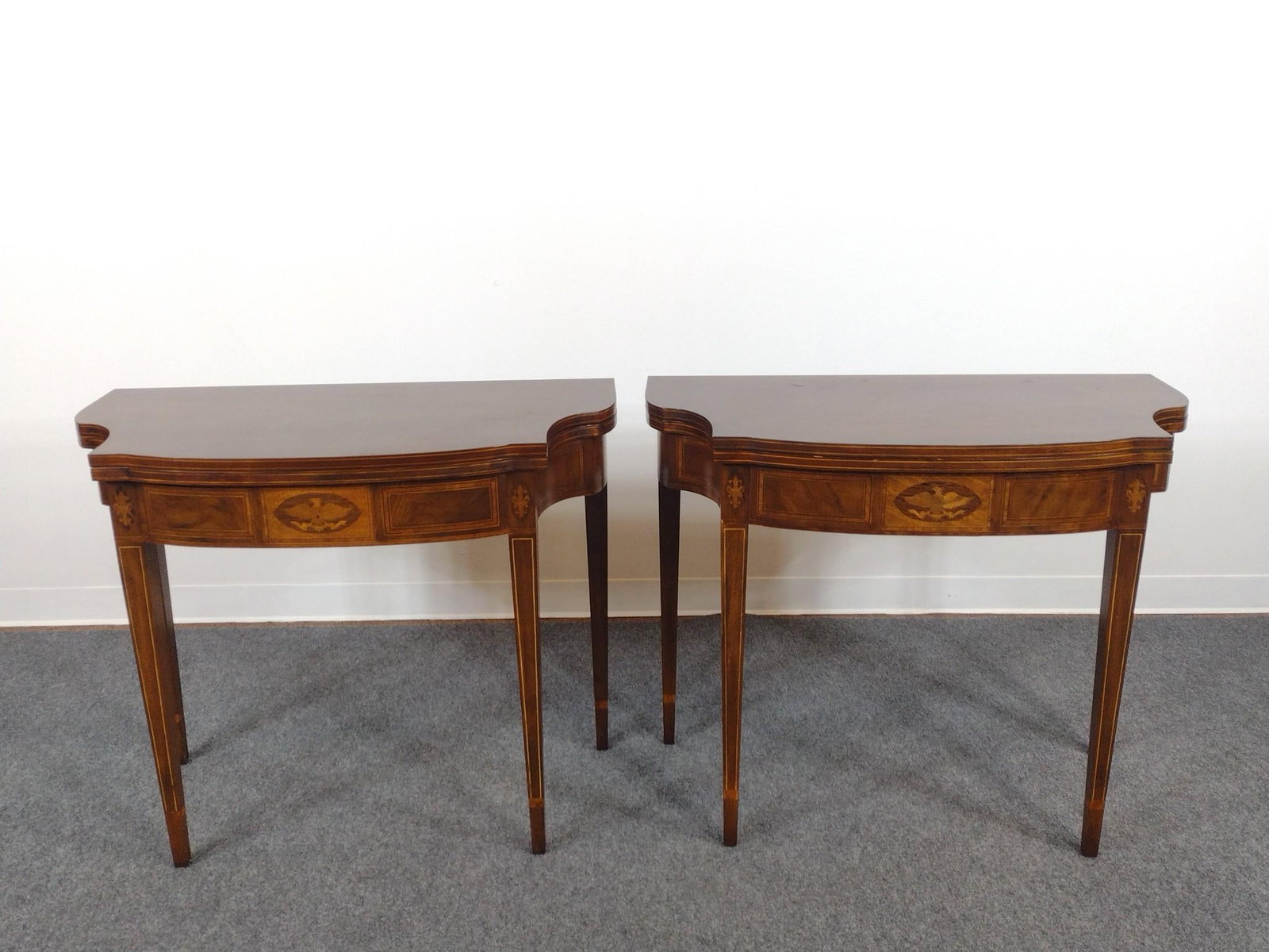 Pair of Baker Furniture Inlaid Game Tables: Each 36-3/4" wide X closed 18-1/2", open 37" deep X 30-1/4" high. Both have light scuffs. PROVENANCE: Acquired by Consignor from the notable Helms family estate (founders of Helms Chevrolet) in Camp H