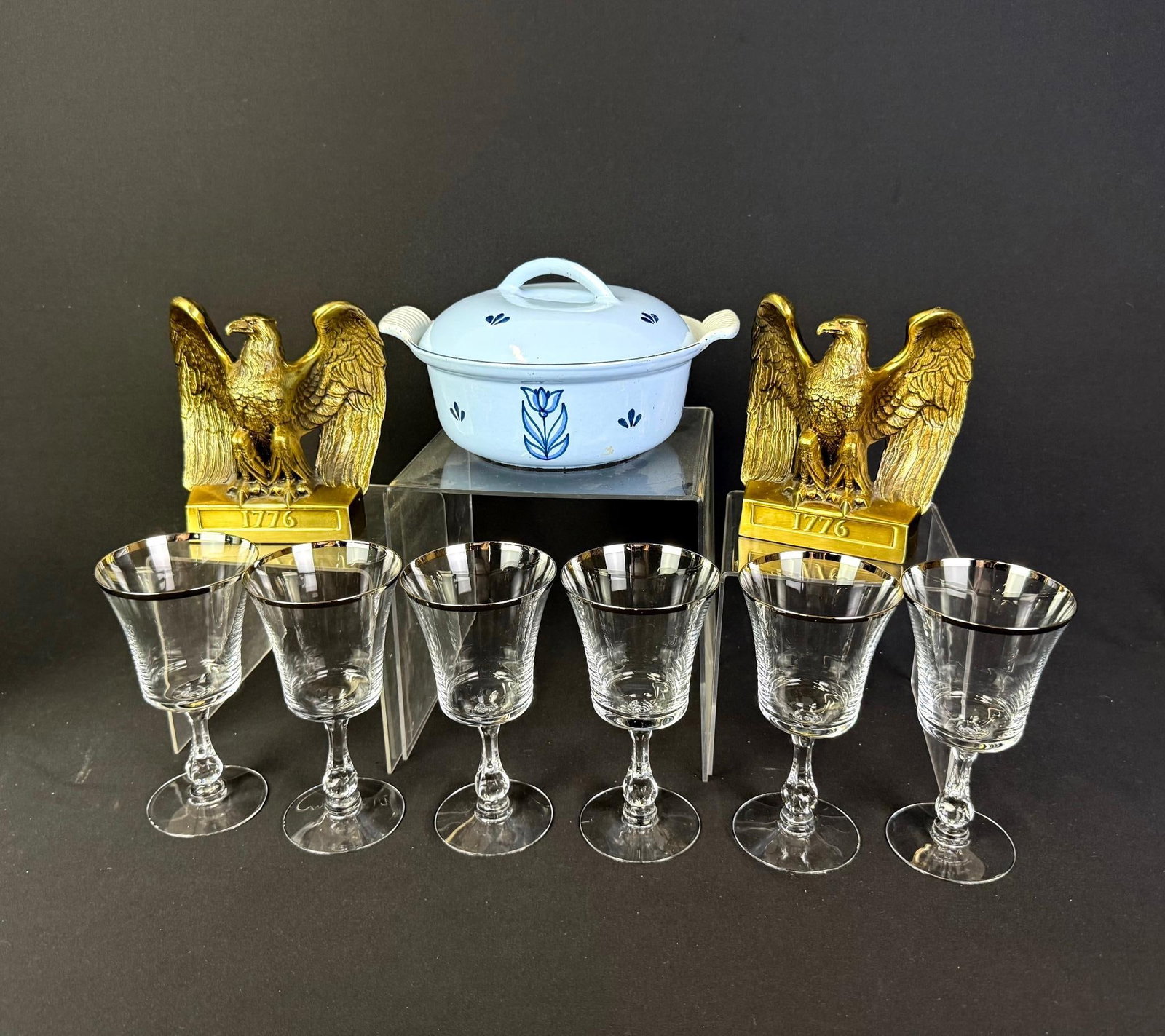 9 Vintage Decor and Crystal: Includes Fostoria wine glasses, enamel cast iron lidded pot, and eagle bookends. Glasses measure 3-3/4" wide x 6-3/4" high. 