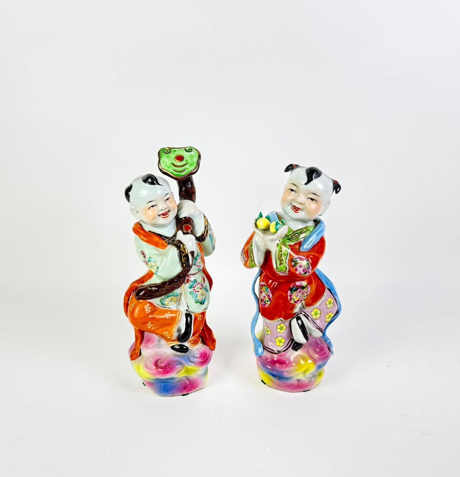 Pair of Chinese Porcelain Figurines: Often referred to as "Golden Boy" and "Jade Girl" representing prosperity and luck. 5" to 6" wide x 13-1/4" to 14" high. 