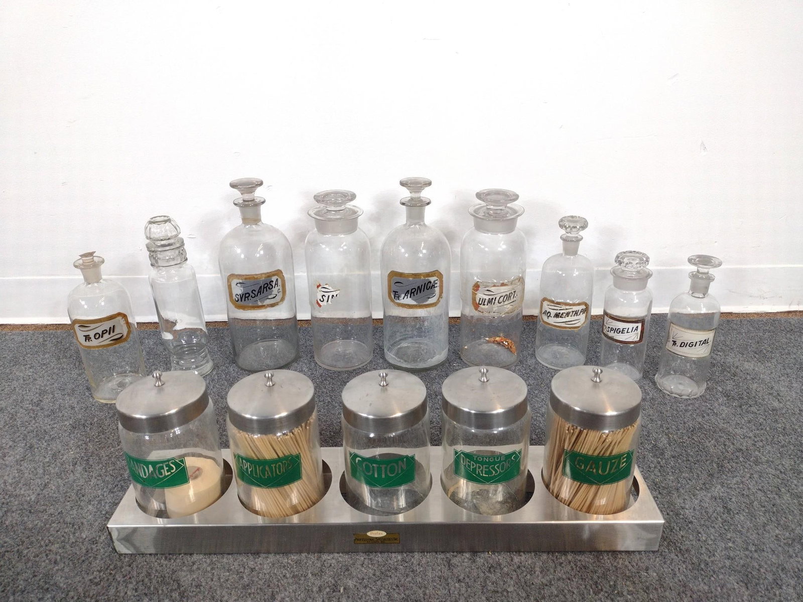 12 Antique and Vintage Glass Apothecary Bottles: 3" to 4-1/2" wide x 8" to 12" long. 