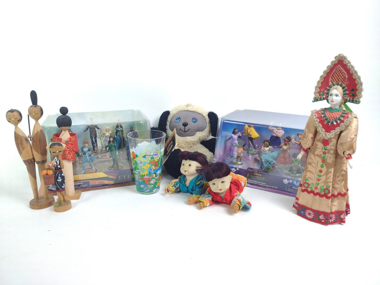 Russian and Japanese Souvenirs, and Disney: Encanto, Eternals, wood dolls, miniatures, plush. 3-1/2" to 11" wide x 6-1/2" to 12-1/4" high. 