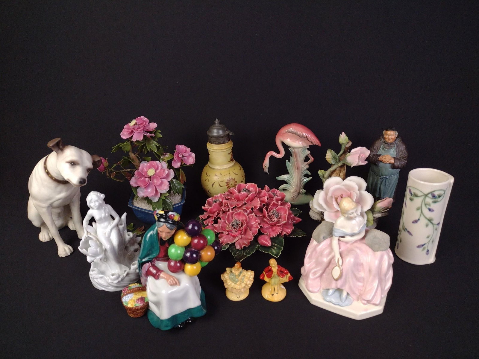 Porcelain Figurines and Decor: Includes Royal Doulton The Old Balloon Seller, Brad Keeler flamingo figurine, "Nipper" by RCA Corp. and more. Largest piece measures 4" x 9" x 9-1/2". Smallest pieces measure approximately 2-1/4"