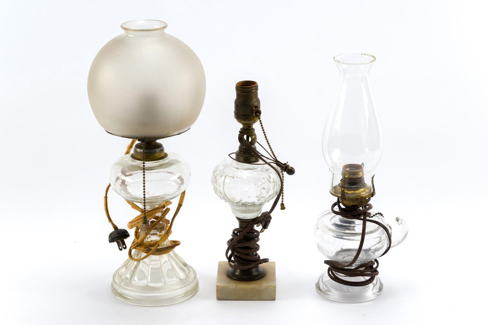 3 Electrified Oil Lamps: All in fair condition, consistent with age and use. Smallest measures 7-3/4"; largest measures 12". 