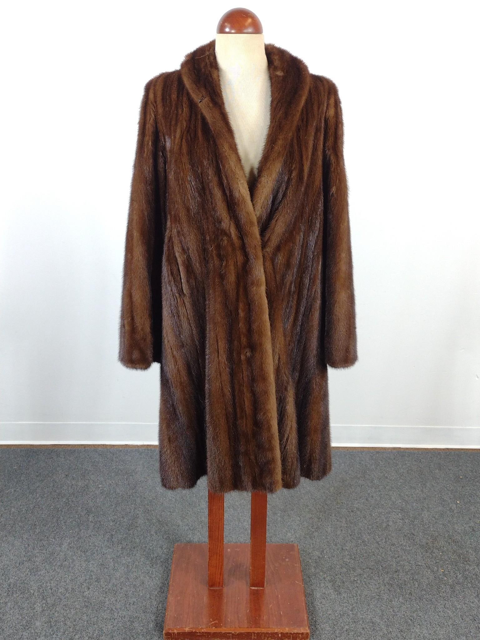Mink Fur Coat: In good condition. Inside, near the armhole, there is some tearing in the satin. Monogrammed stitching on the inside "H.R.H". Measures from collar to end 43-1/4".
