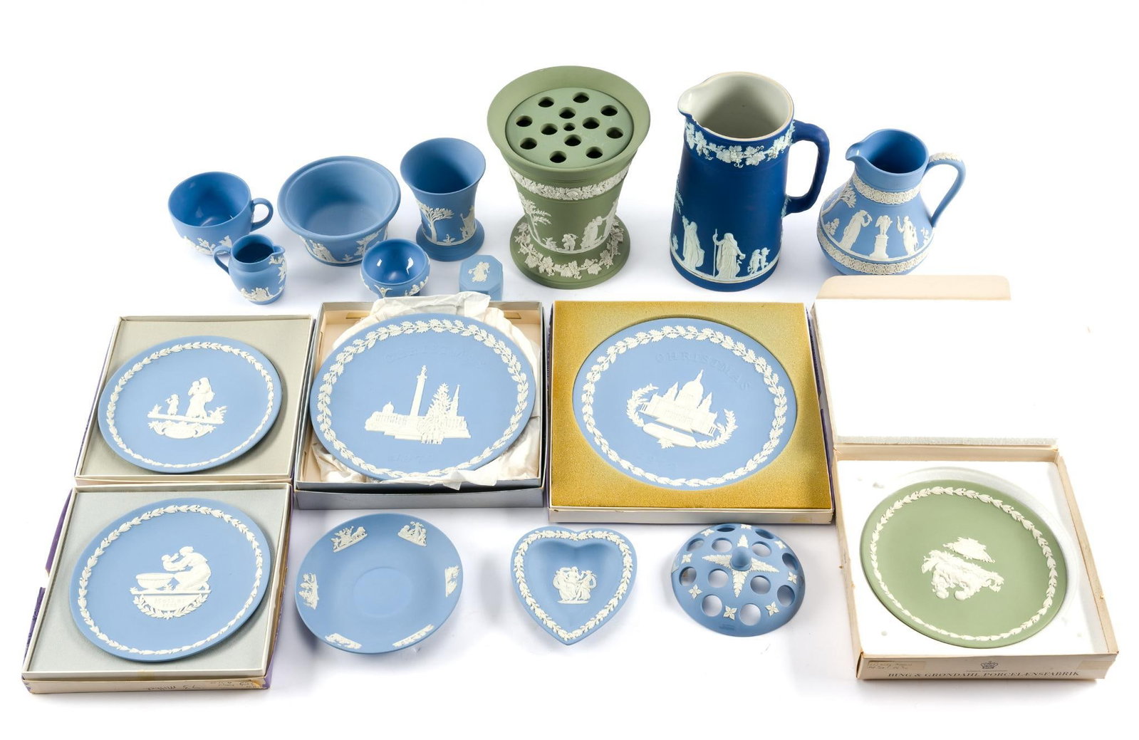 Wedgwood Jasperware Pitchers, Plates, Flower Frog, and More: Includes sage green vase w/flower frog lid, blue pitcher, collector plates, cups, teacups, saucers, and more. All in fair condition, some chipping on a few items. Smallest piece measures 1-1/4"; large