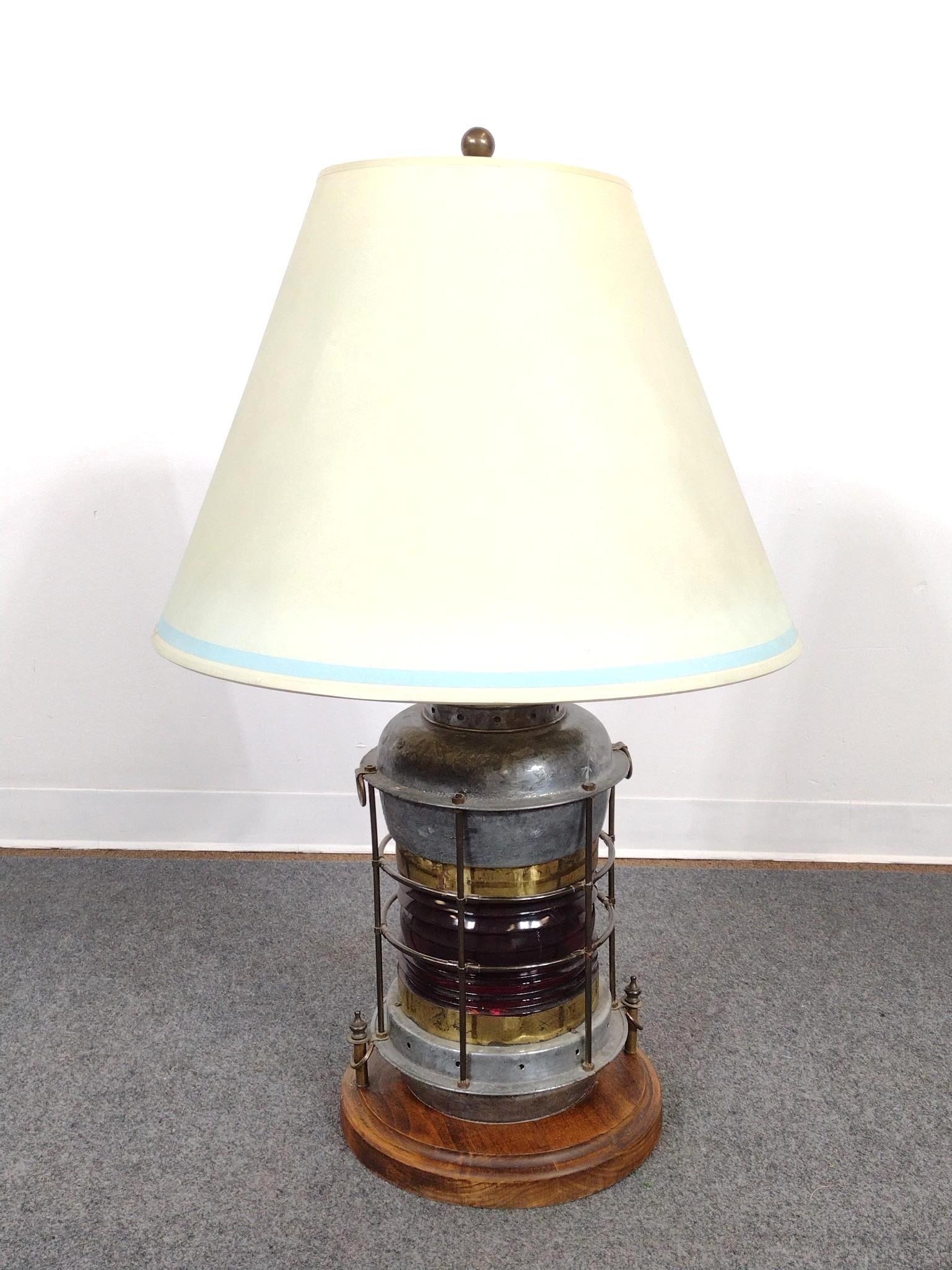 Railroad Lantern Table Lamp: Includes lamp and shade. Some signs of age and use. From top to bottom measures 39" tall. The longest part of the shade measures 18-1/4" tall. Provenance: From the Estate of Lory Patrick Jones