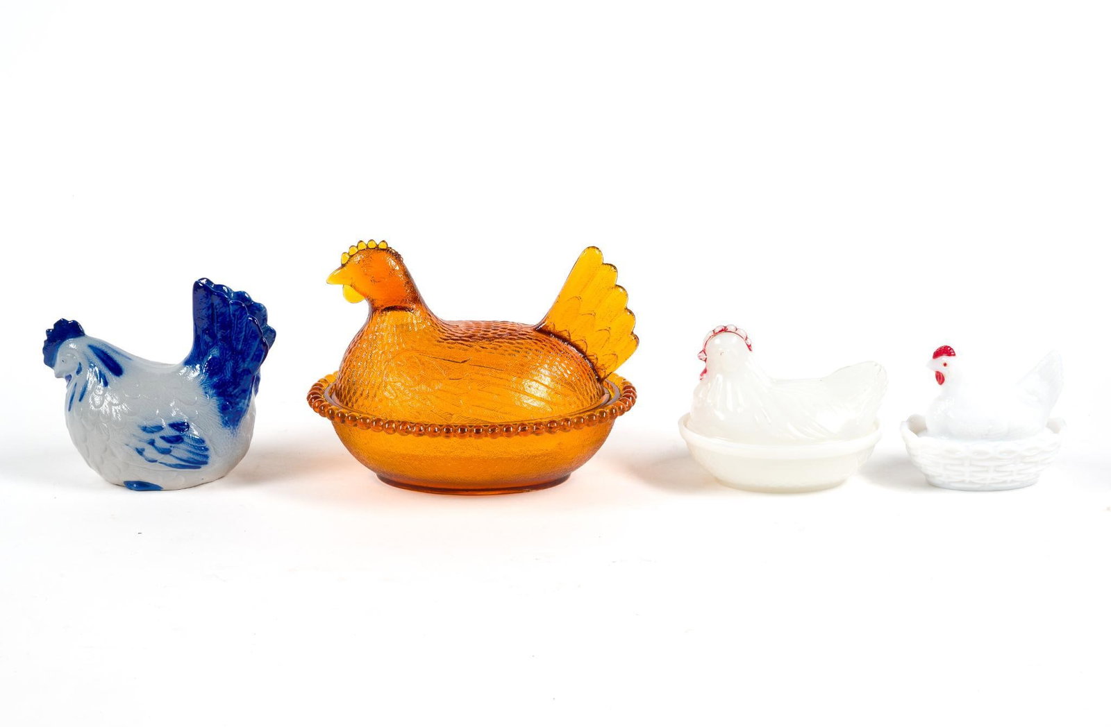 3 Hen-On-Nest & Signed Ceramic Chicken: Includes one amber glass hen-on-nest, 2 milk glass hen-on-nests and a ceramic chicken that is illegibly signed on the bottom. Amber hen-on-nest measures 7-1/4" x 5-1/2" x 5-1/2". 