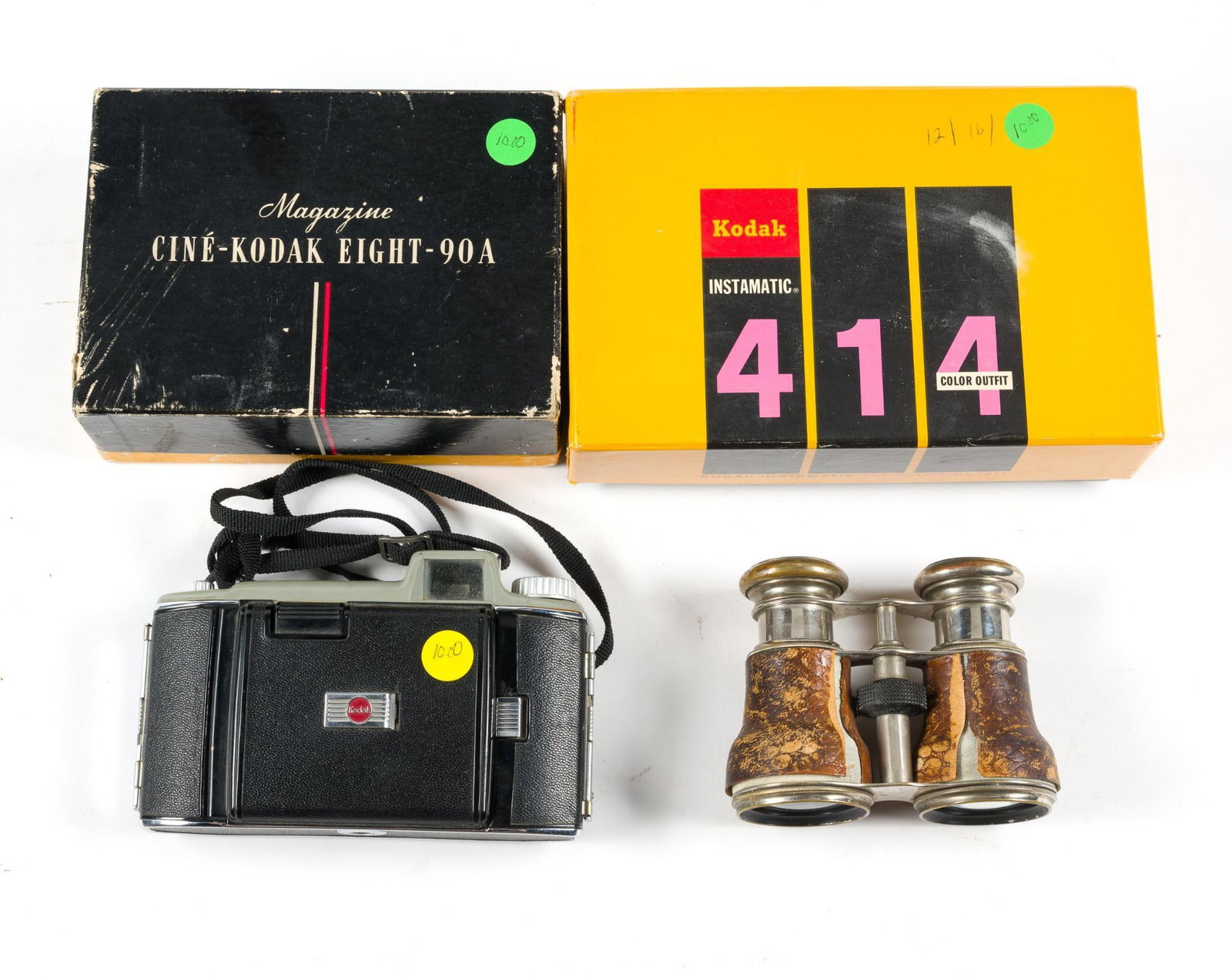 3 Vintage Kodak Cameras & Antique Opera Binoculars: Cinè-Kodak Eight-90A and Instamatic 414 are both in original boxes. One side of the binoculars outer design is peeling. Largest box measures 8-1/2" x 5-1/2" x 2-1/2". 