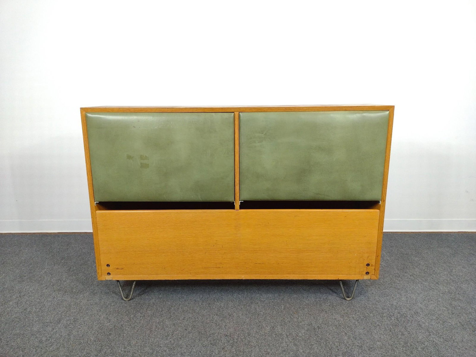 George Nelson for Herman Miller Headboard: Measures 56-1/8" x 12" x 39-1/2". Some scratching and a water ring on the top of the headboard, some blemishes to the green vinyl on the front as well. 