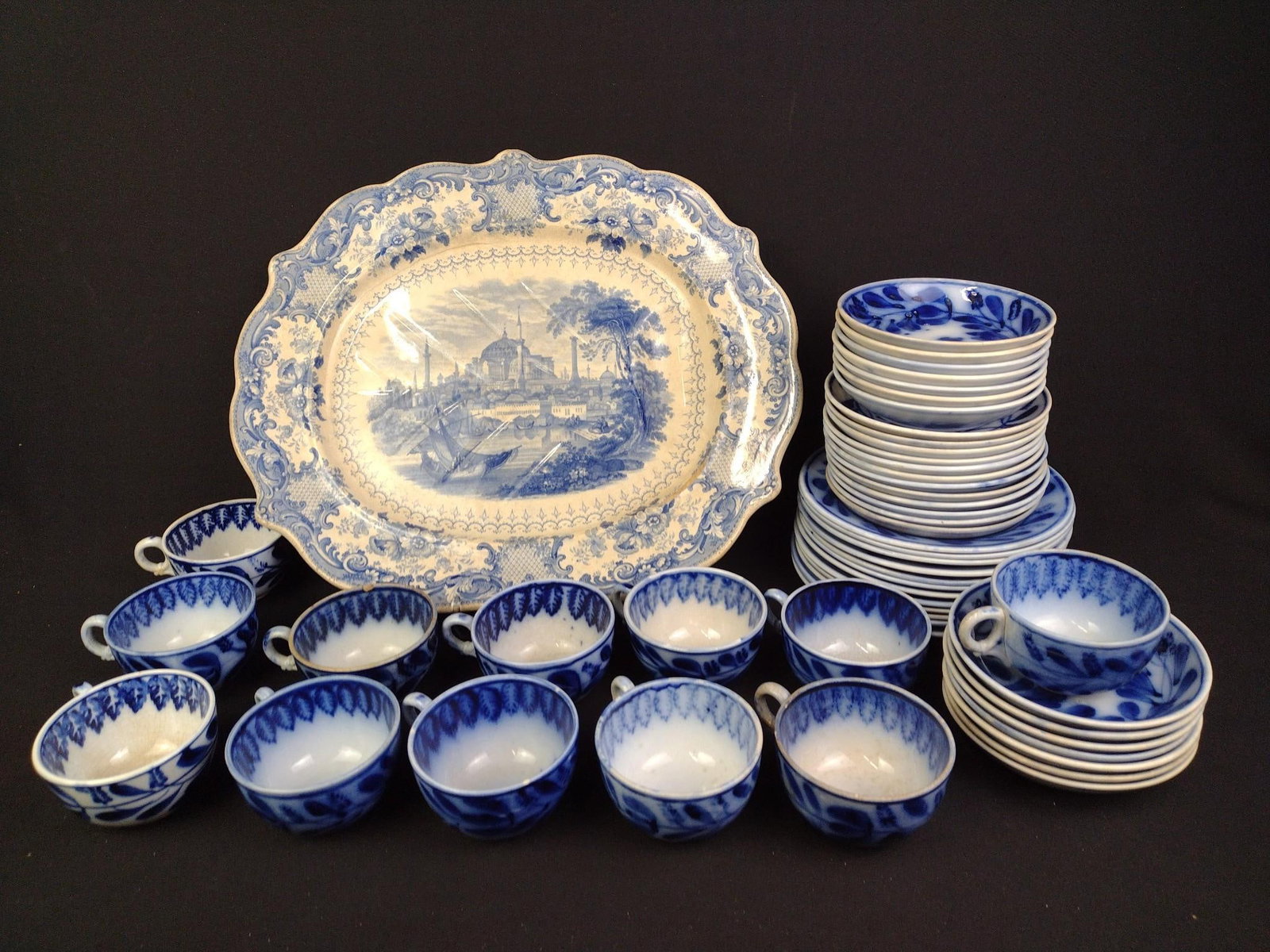Flow Blue Tea Set & Staffordshire Platter: Platter measures 16-1/2" x 14-1/2" and saucers measure 5-3/4" in diameter. Some wear and discoloring. 