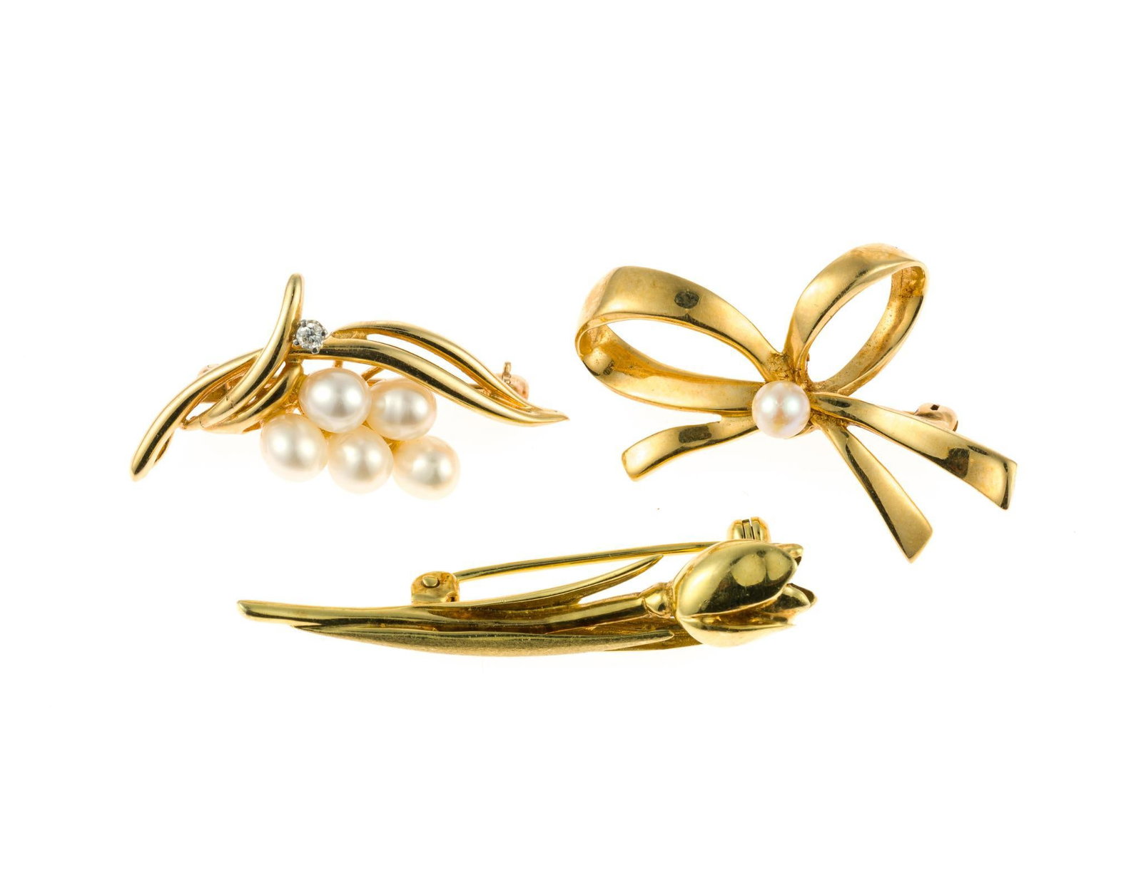 Three 14K Gold Brooches: Three yellow gold brooches with approximate lengths of 1 1/2". Includes pearls and diamond. The total weight is 13.0 grams.