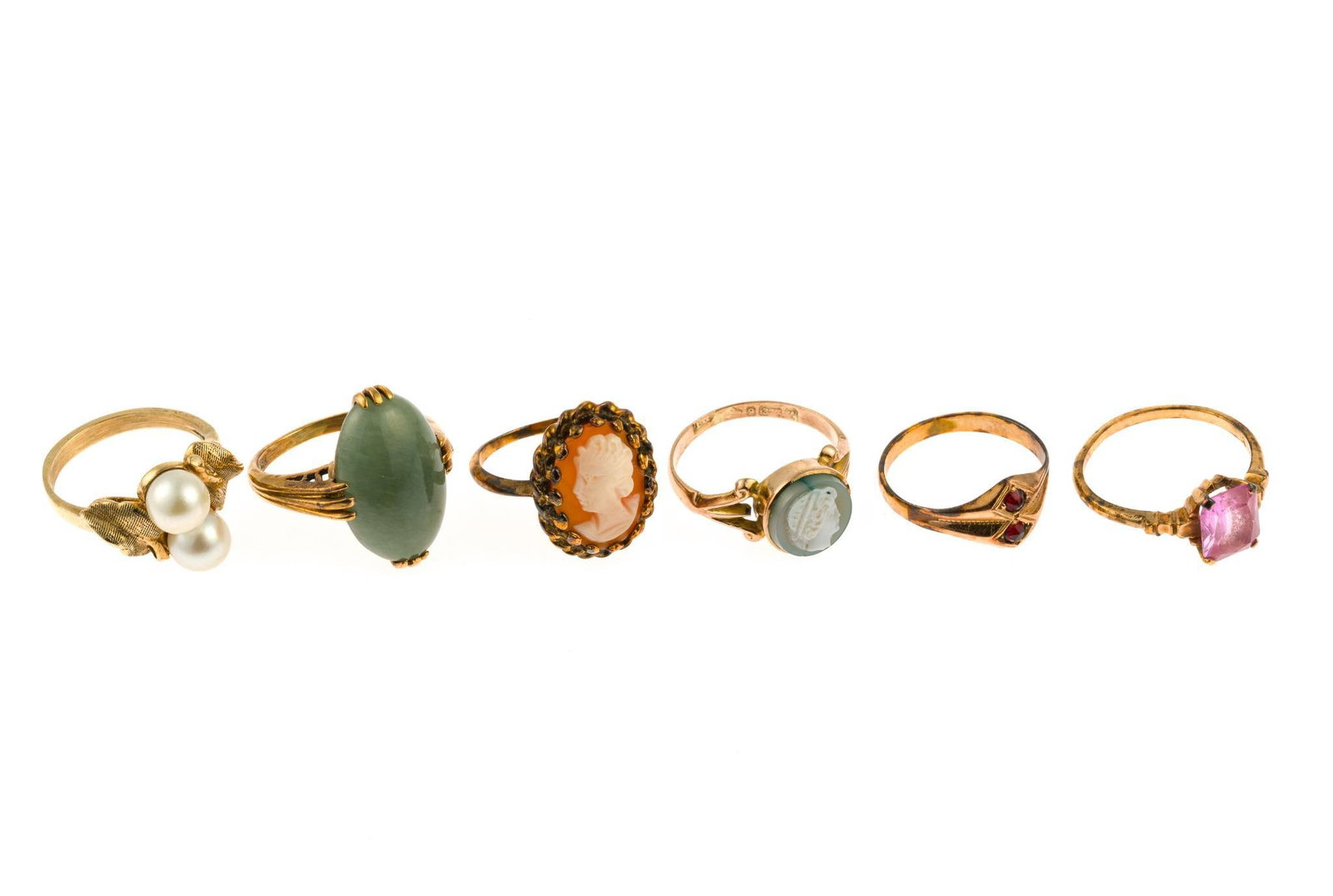 Six 10K Gold Rings: Six rings consisting of two rings that are marked 10k, one, the smaller cameo, is European rose gold 9k (marked 375) while two rings test 10k and one rose gold ring with pink gemstone tests 10k. The r