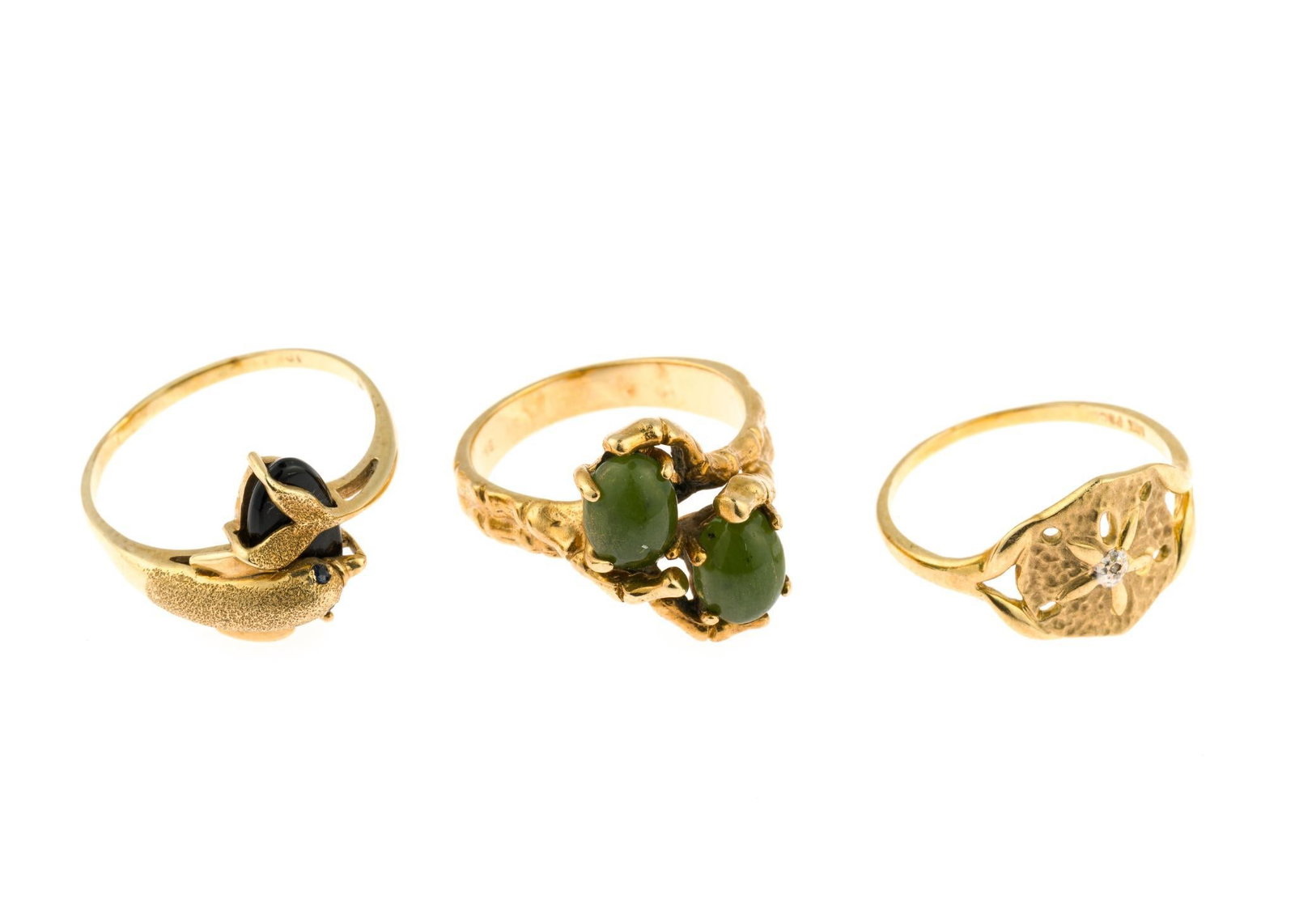Three 10K Gold Rings: The rings range from size 7 to size 9. One with a dolphin figure has onyx and a second has jade gemstones. The total weight is 10.7 grams.