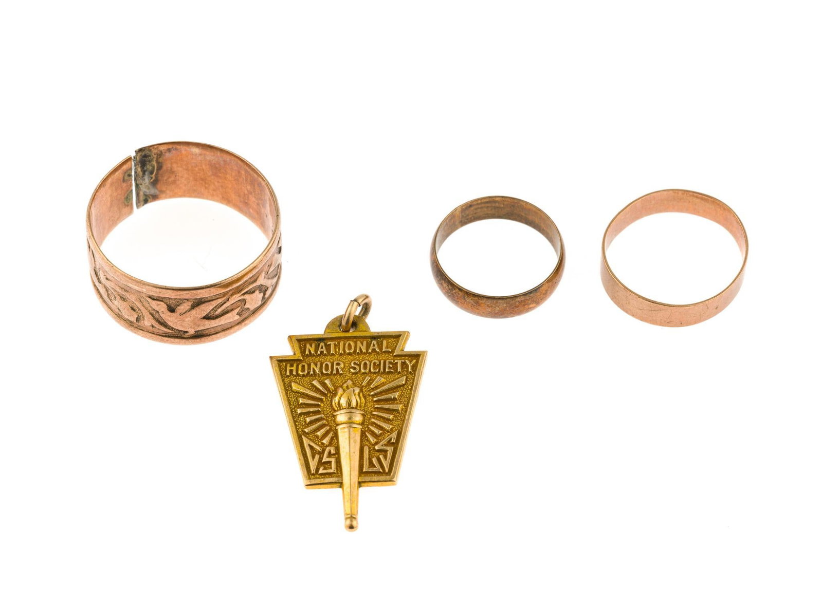10K and 9K Scrap Gold: A split band testing 9k with weight of 3.1 grams, two small rings testing 10k and a marked 10k National Honor Society pendant. Total weight of 10k items is 4.2 grams