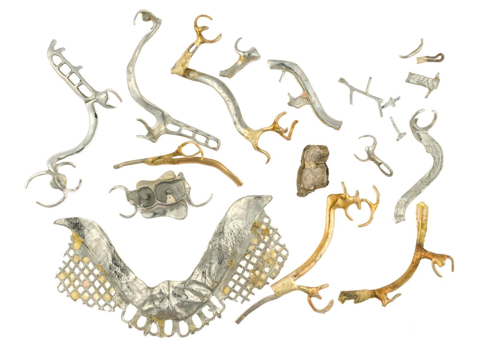 Scrap Dental Gold, Platinum, and Palladium: Generally yellow metals tested 18k, the white metal bridge plate tests 18k while some white metal pieces test platinum and possibly palladium. The set of two caps did not test well and may be palladiu