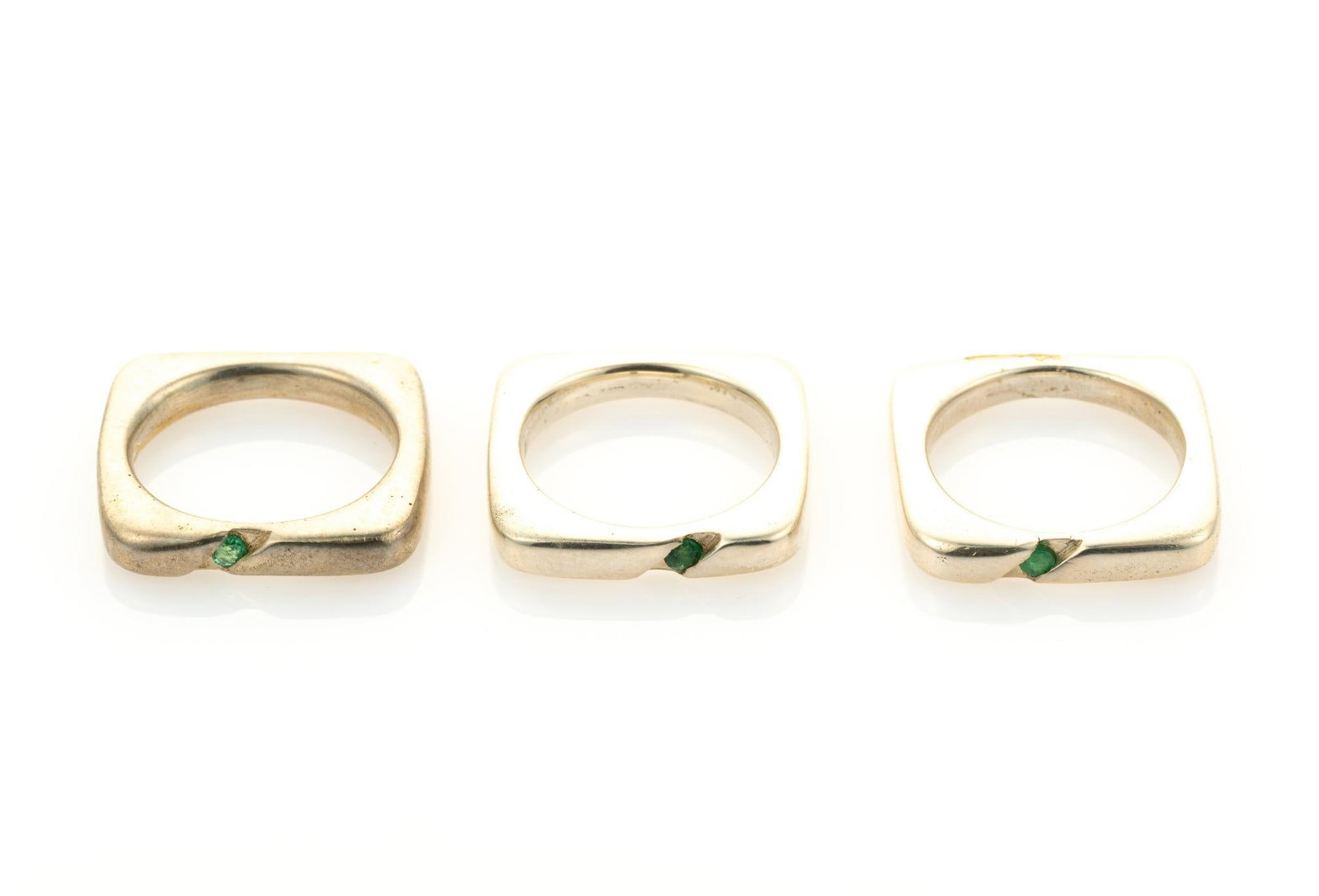 3 Sterling Silver And Emerald Rings: All round cut, natural, SI clarity. Ring sizes 5 to 5.75. Total 0.59 ozt. Gemstones include Amethyst & 2 Rhodolite. Amethyst is purple, round brilliant cut, natural, VS clarity. Rhodolite are ras