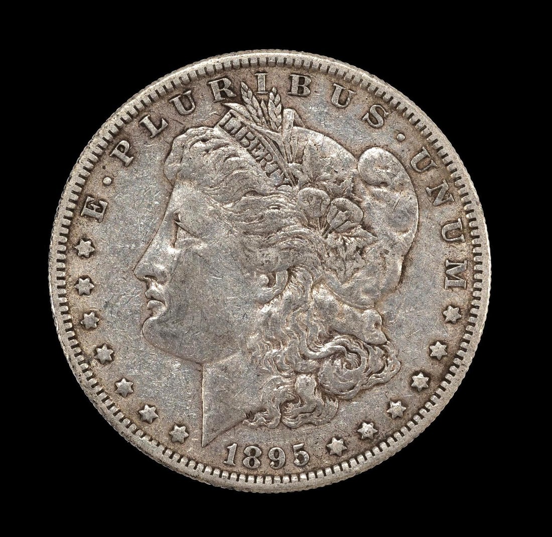 1895-O New Orleans Mint Silver Morgan Dollar: 1895-O with no damage or obvious past cleaning hairlines. Approximately VF25. One noticeable circulation mark obverse right field left of the star below M.