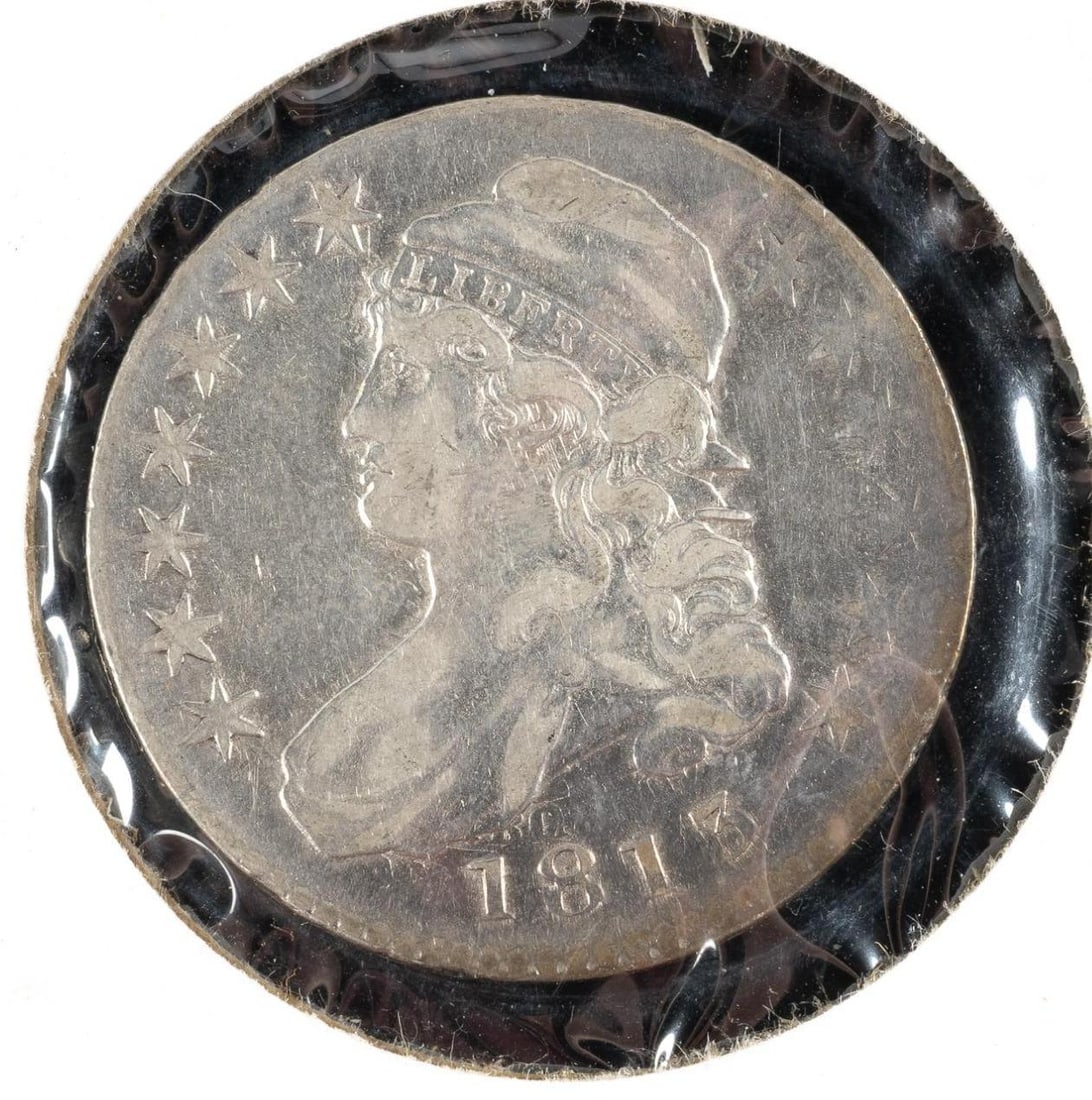 1813 Capped Bust Half Dollar: An 1813 half in XF showing scattered light hairlines. It has heavily clashed dies of the reverse showing on the obverse. 