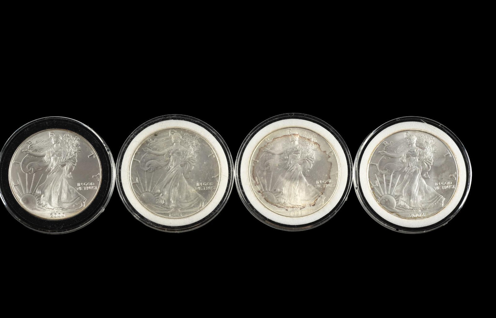Four American Eagle Silver Dollars: All are uncirculated one ounce pure silver each.