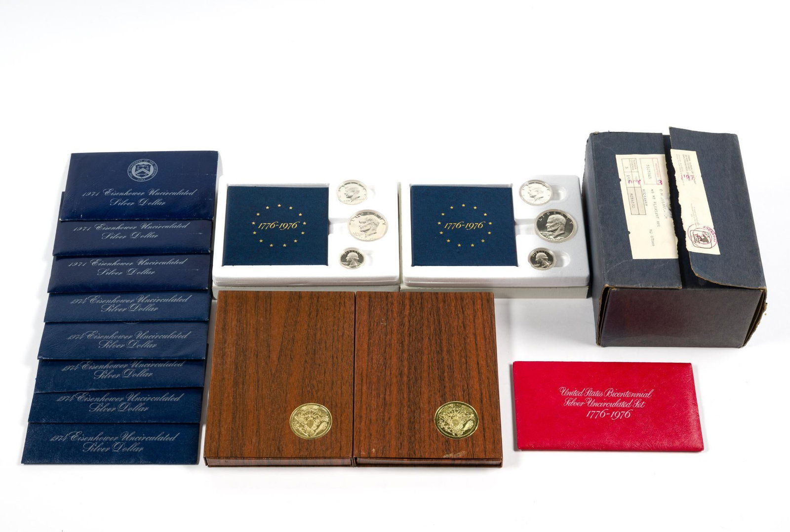 Eisenhower Proof And Uncirculated Silver Dollars: Eight uncirculated Eisenhower silver dollars and seven silver proofs. Also there are three 3-coin Bicentennial Silver Sets. All of the coins are 40% silver. 