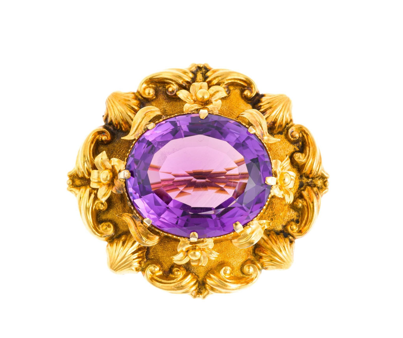 Victorian 20K Gold and Amethyst Brooch: Approximately 33 carat oval faceted amethyst mounted in a detailed high carat gold setting with floral theme. The piece is unmarked and tests 20k and weighs 14.9 grams. It has a length of 1 5/8".