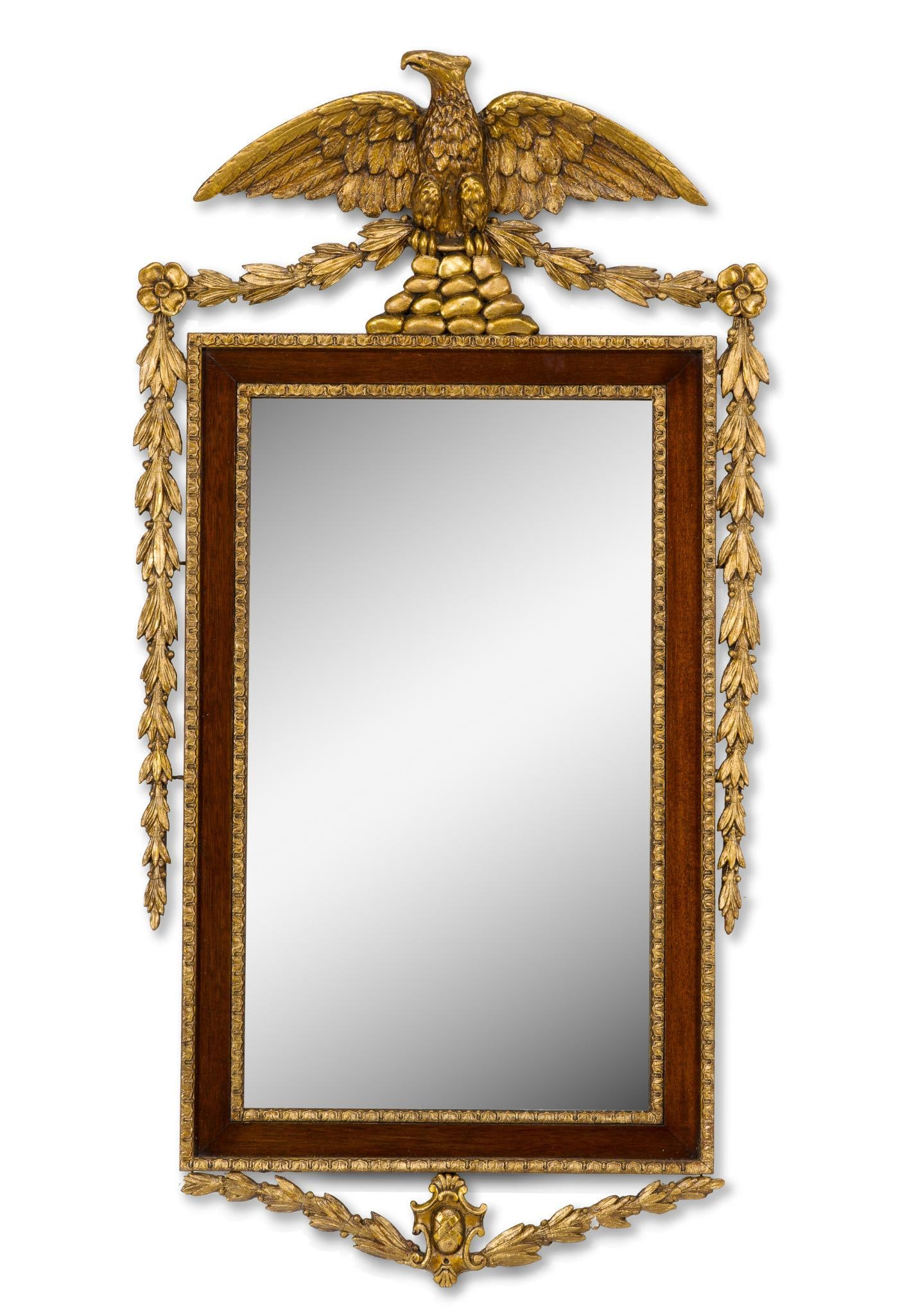 Federal Style Giltwood and Mahogany Eagle Mirror: Federal-style giltwood and mahogany mirror, the rectangular frame with molded gilt foliate borders and mahogany panels, surmounted by an imposing spread-wing eagle perched upon a rocky base and