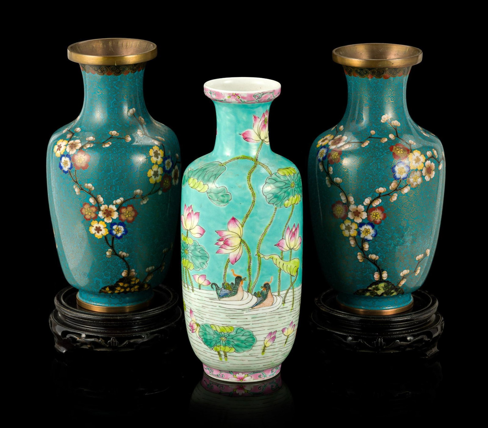 3 Chinese Vases Incl. Cloisonne and Famille Rose: Includes pair of floral patterned turquoise cloisonne enamel vases with Asian wooden stands and a porcelain lotus pond scene famille rose vase. No markings. Small chips and slight wear on wooden stand