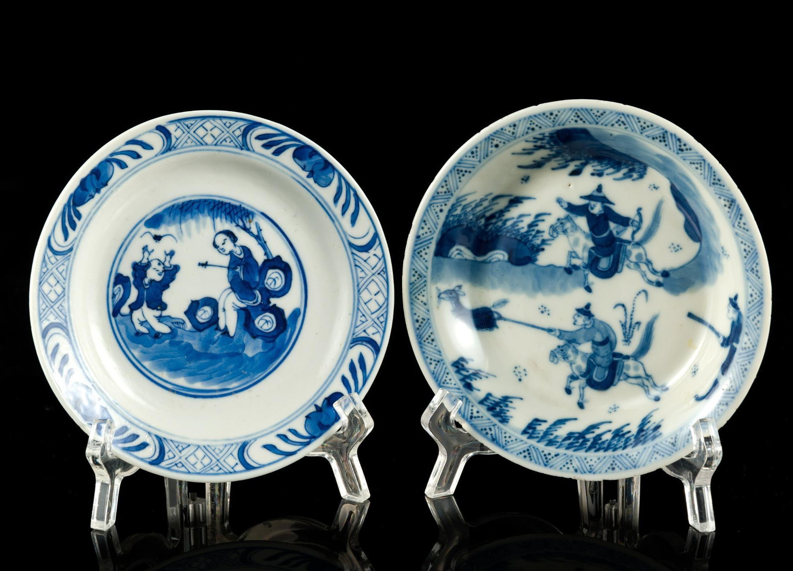 2 KangXi Chinese Blue and White Saucers: One an 18th century Kangxi piece, 5 1/4" diameter, with warriors on horses. It is Yu marked to the bottom and has small chipping to the rim. The second saucer is 5 1/8" diameter and is marke