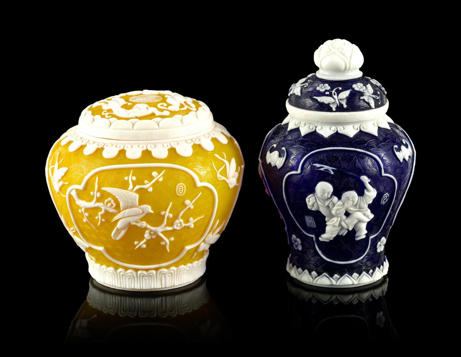 2 Chinese Peking Glass Overlay Lidded Jars: One 4" height creamy white on yellow and has a raised Qianlong mark to the base. The second is white on blue, 5 1/2" height, and has an incised mark to the base.