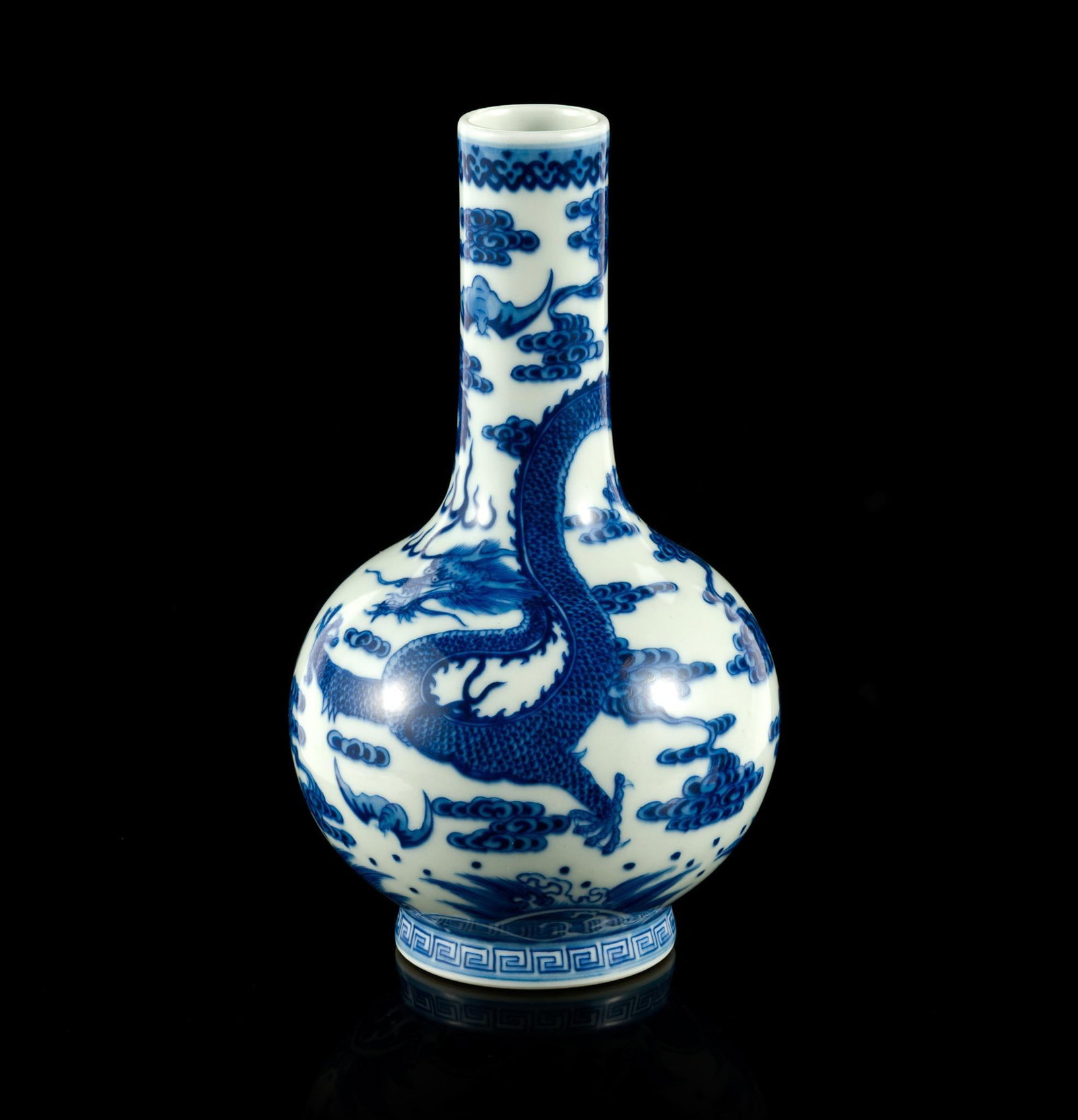 Chinese Blue and White Dragon Vase: A 7 1/2" height blue and white vase with six character Qianlong mark to the base in blue. It has not damage or repairs.