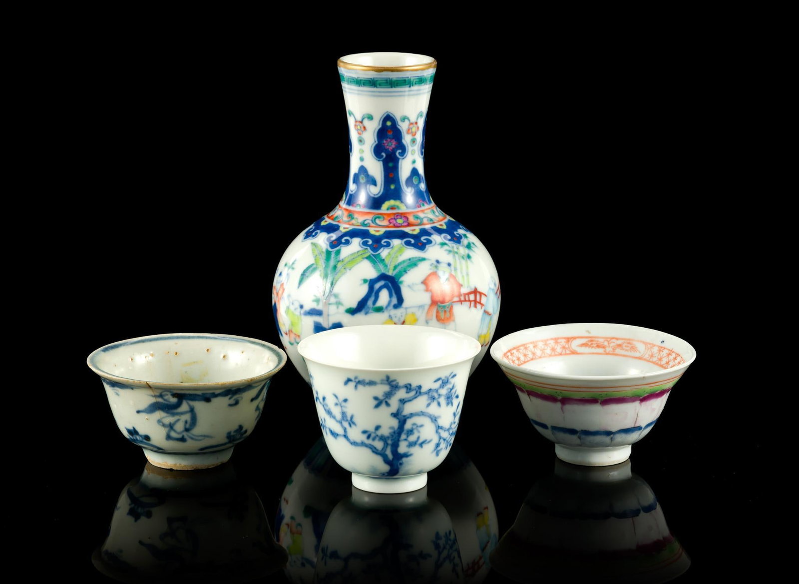4 Chinese Porcelain Vessels: Includes three wine cups and vase. Two of the cups are stamped. Vase is also stamped on bottom. Vase 3-1/4" wide x 5-1/2" high. Cups 2-1/2" to 2-7/8" wide x 1-1/2" to 2" high. 