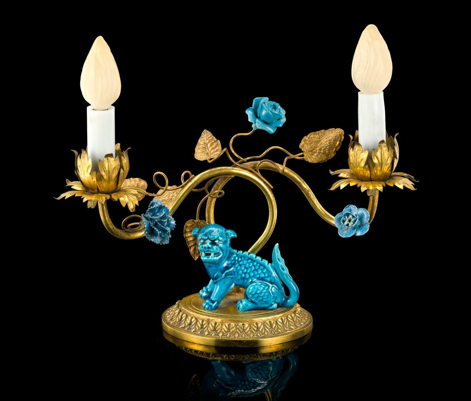 Chinese Ceramic and Gilt Bronze Foo Dog Lamp: A 1920's Chinoiserie style boudoir lamp with central turquoise blue glazed ceramic foo dog and gilt bronze floral lamp holders. It is 10" height by 10" width.