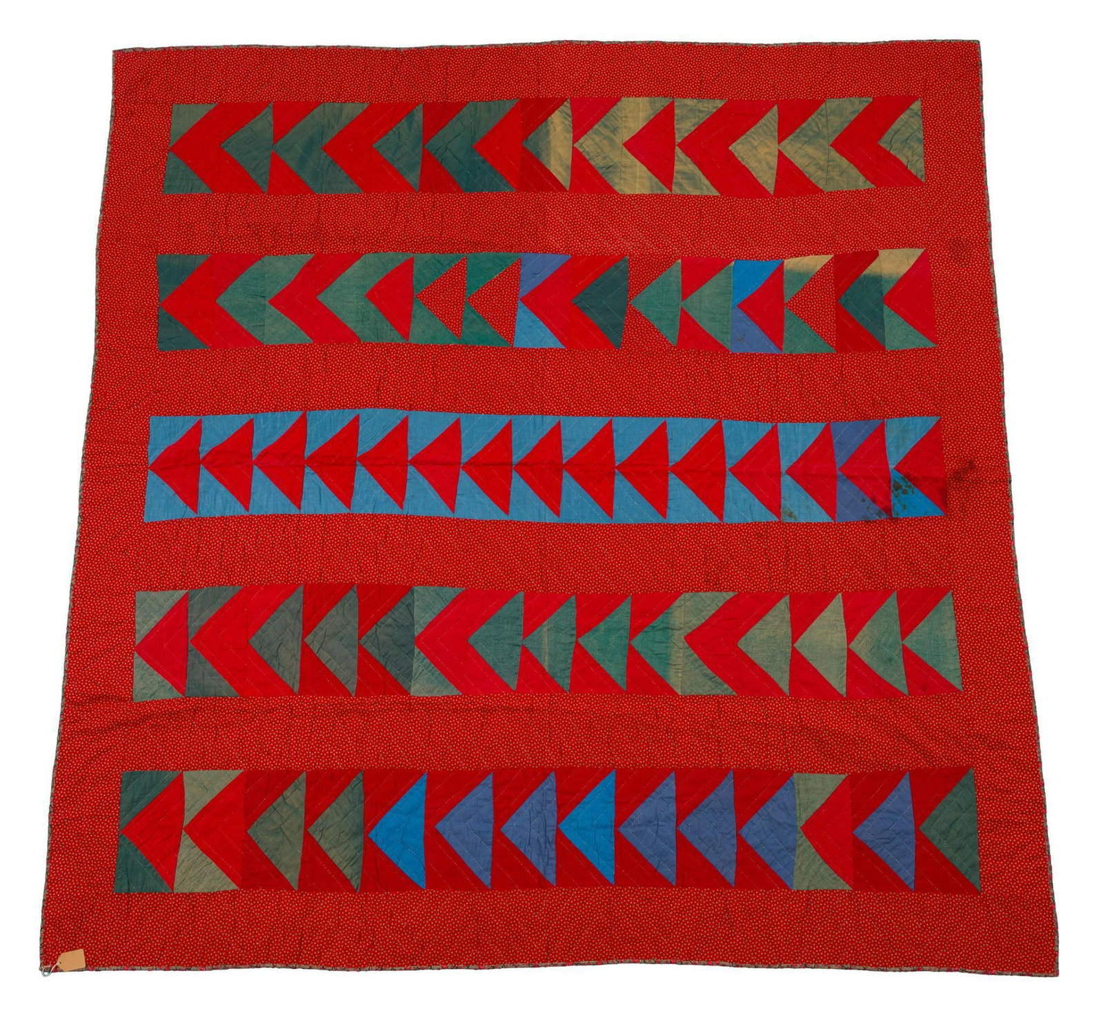 Circa 1860 American Chevron Quilt: American pieced quilt, circa 1860s, composed of five horizontal bands of repeating angular chevron or zigzag motifs, constructed from small geometric pieces in red, blue, green, and tan cottons and se