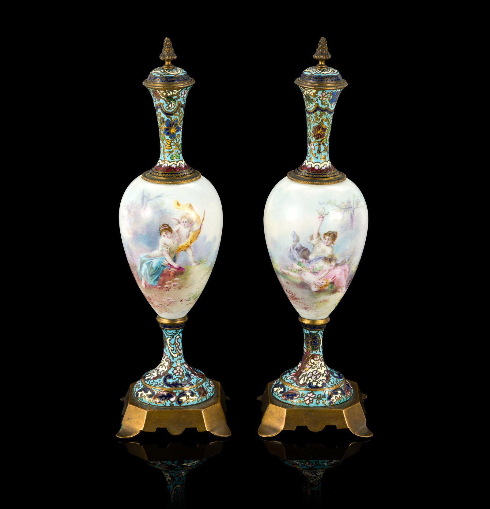 Pair of French Sevres Style Porcelain and Enamel Lidded Urns: A matched pair of Sevres style lidded vases or urns with hand painted scenes to the porcelain bodies and cloisonne work top and bottom. The vases are 13 1/2" in height.