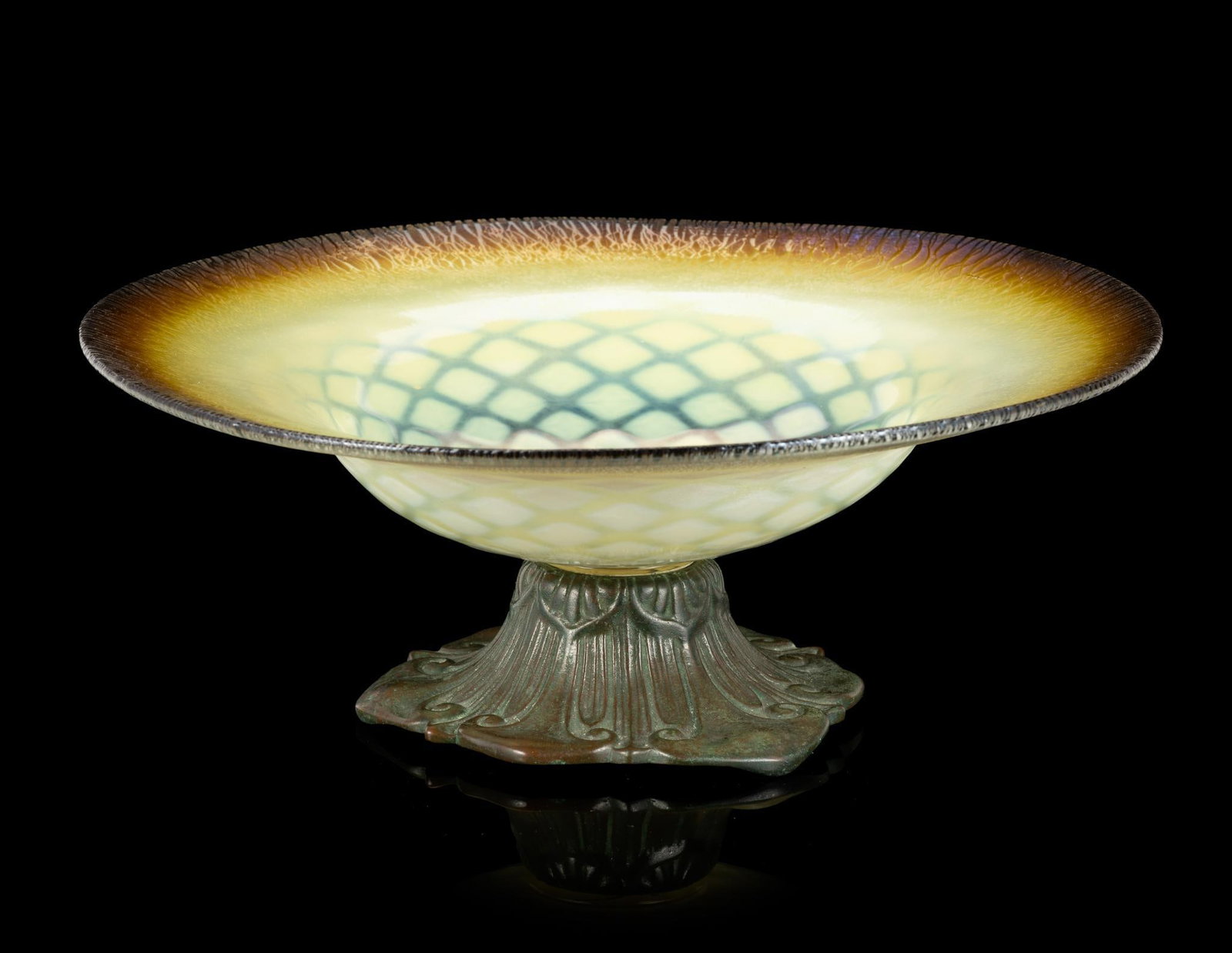 Louis C. Tiffany Furnaces Bronze and Favrile Glass Centerpiece Bowl: A Tiffany bronze footed centerpiece bowl from the mid 1920's. The bronze is stamped Louis C. Tiffany Furnaces 500 and has the Tiffany Studios logo as additional stamped mark. The Favrile glass bowl ha