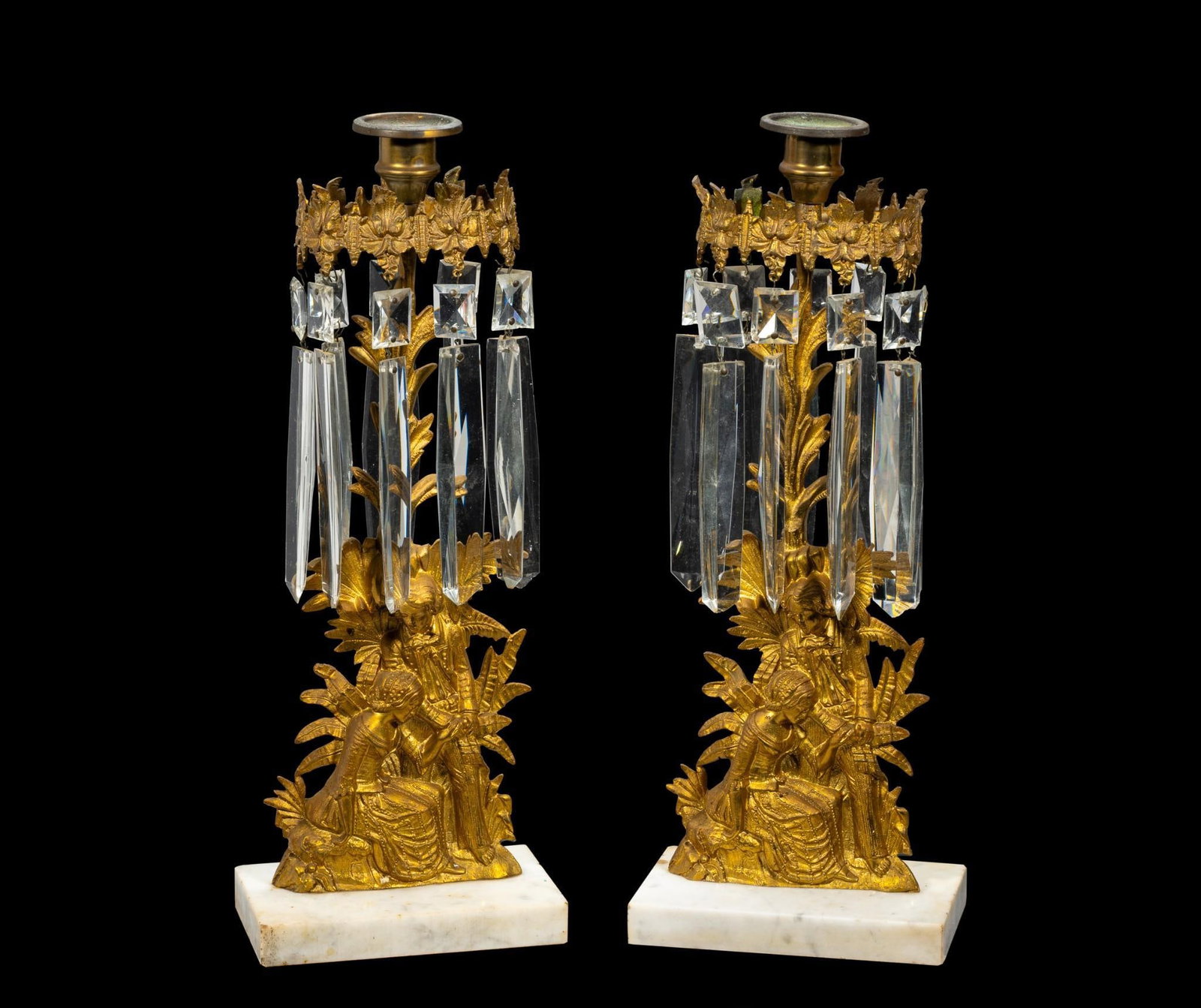 Pair of 19th C Rococo Revival Girandole Candlesticks: Gilt bronze figural forms on marble bases. Some chips to prisms and one is repaired. Both measure approximately 6" x 4" x 16".