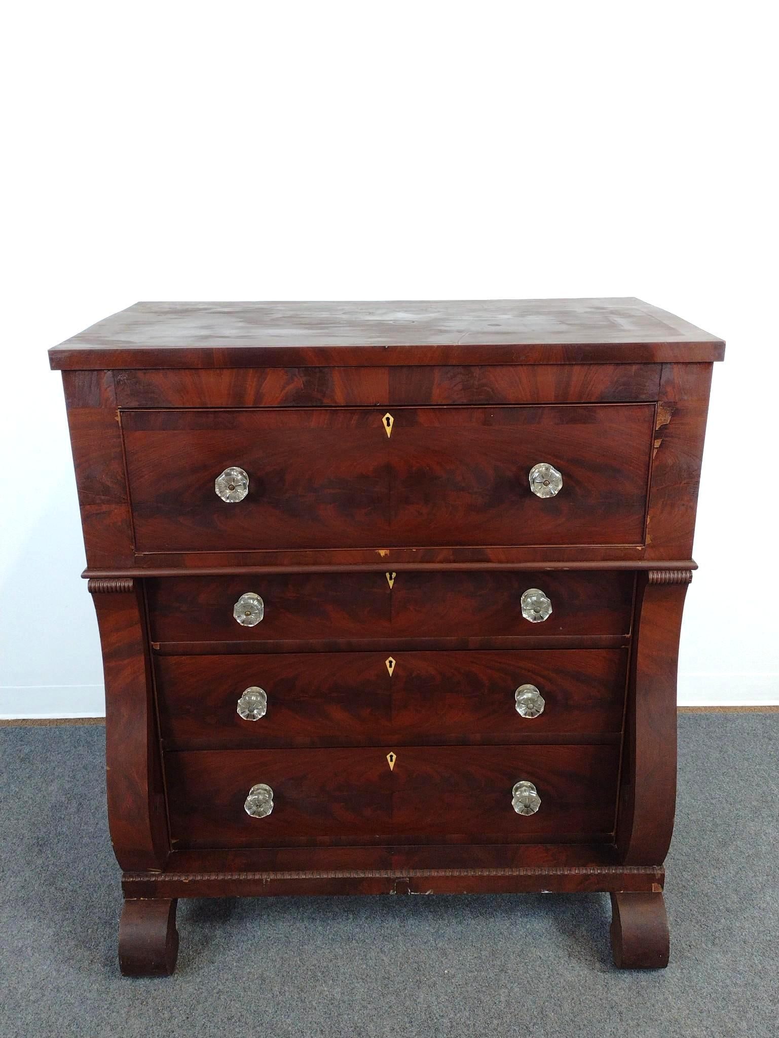 American Empire Chest of Drawers: Glass pulls. 19th century. 41-1/2" wide X 22-1/2" deep X 47" high. Has scratches and areas of finish loss. 