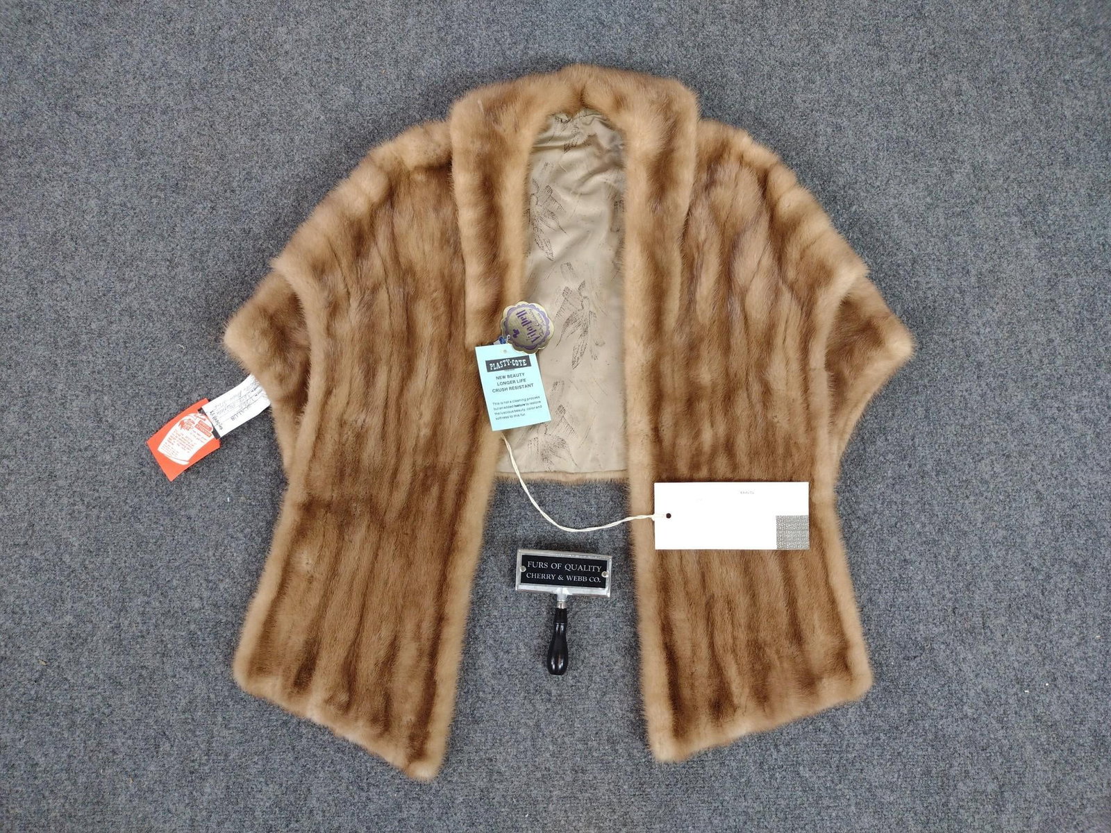 Mink Fur Stole & Furrier Brush: Mink fur stole, shoulder to shoulder measures ~ 18". Includes furrier brush with "Furs Of Quality Cherry & Webb Co." engraved on top. Both in good condition. With dry cleaning tags.