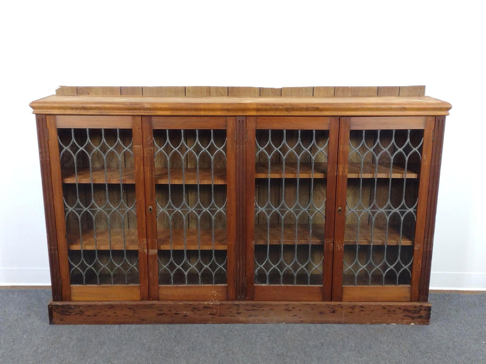 Glass Door Low Bookcase Library Cabinet: 70-1/2" wide X 11" deep X 43-1/2" high. Has scratches and finish loss.