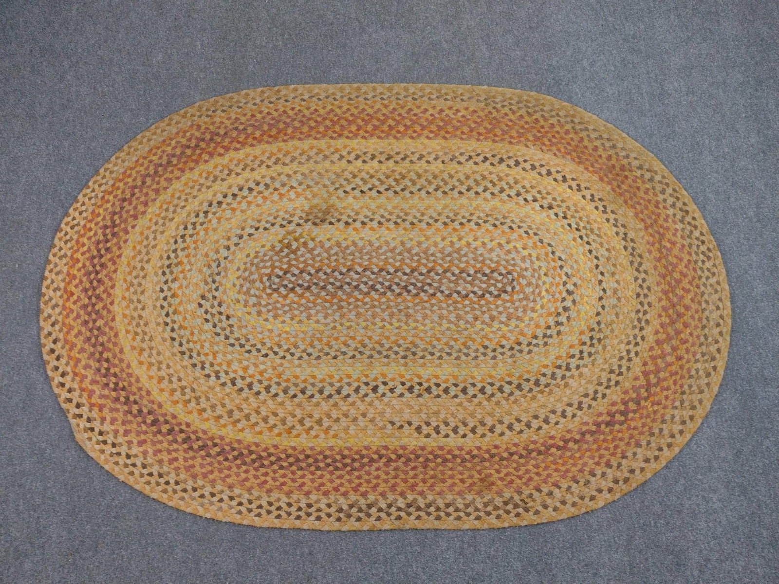 Braided Area Rug: 8'2" long X 5'7" wide. Has spots of discoloring.