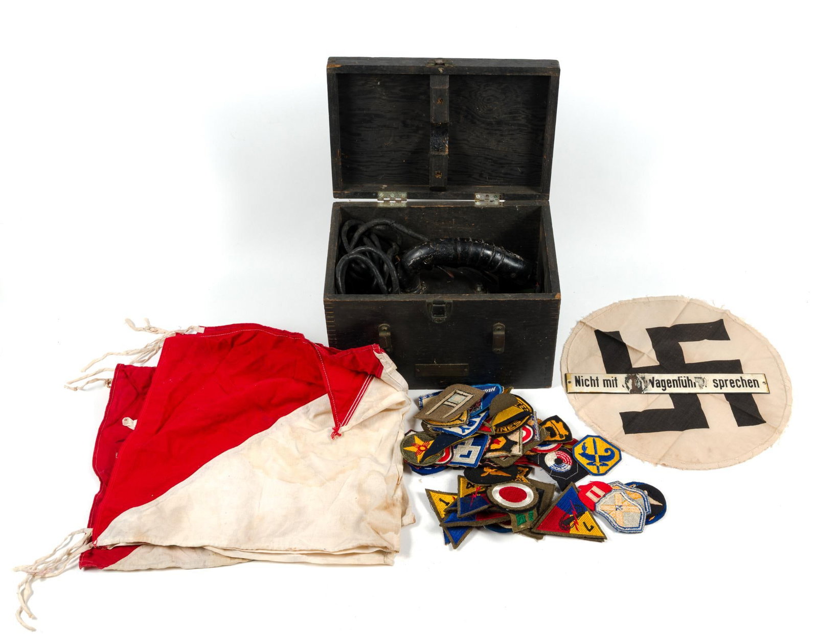 English Aldiss Lantern, WWII Signal Flags & German WWII Flag Cut Out: Also includes a German trolley sign with some damage and a collection of Army/Navy patches. Aldis lantern (daytime signal lantern) box measures 13" x 8-1/2" x 8-3/4". German flag piece is out of